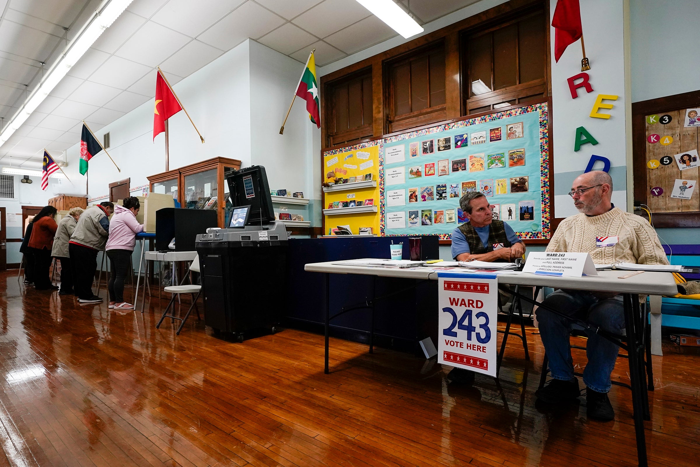 Voters cast their ballots at a school