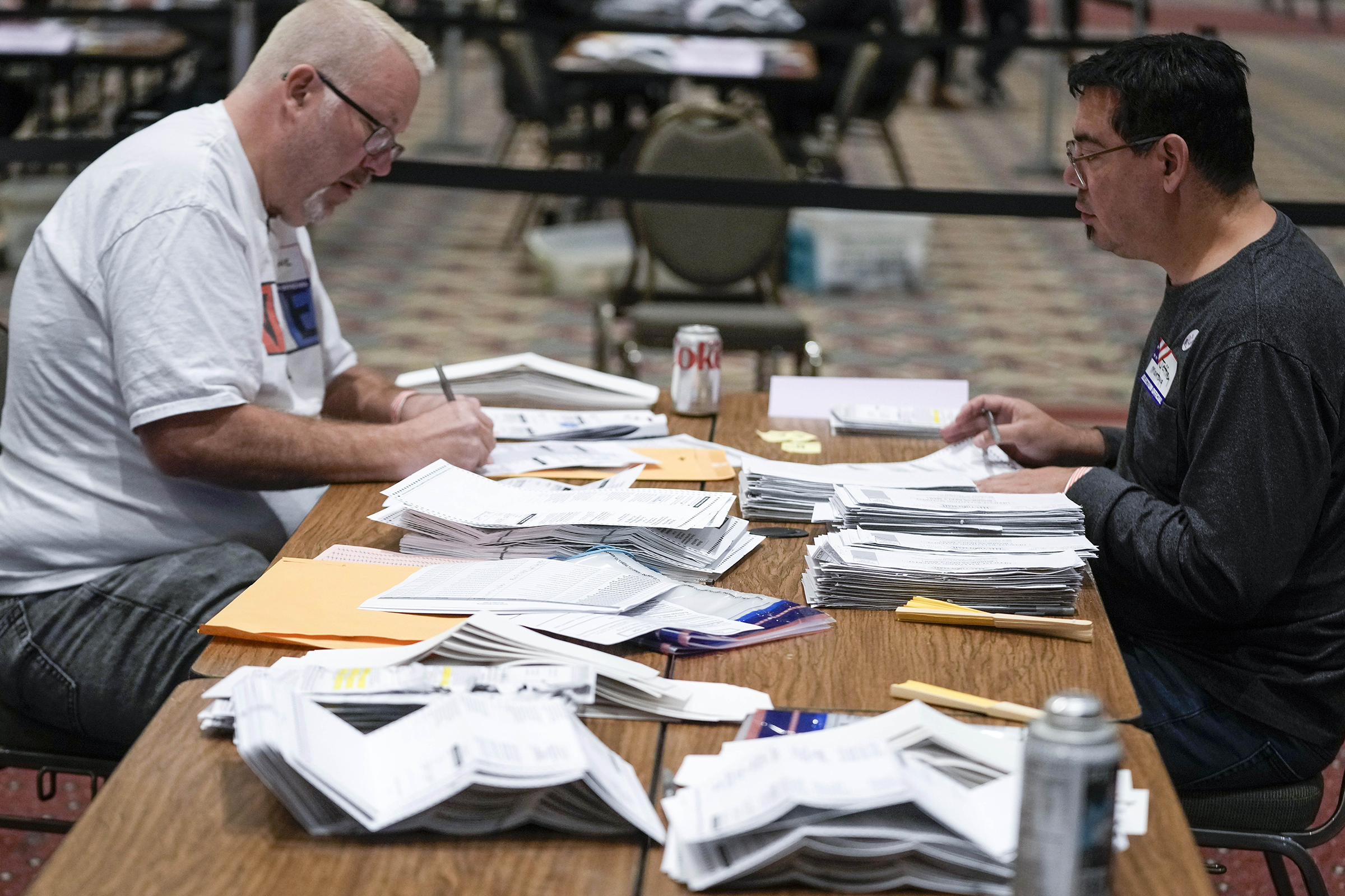 Workers count absentee ballots at the Wisconsin Center f