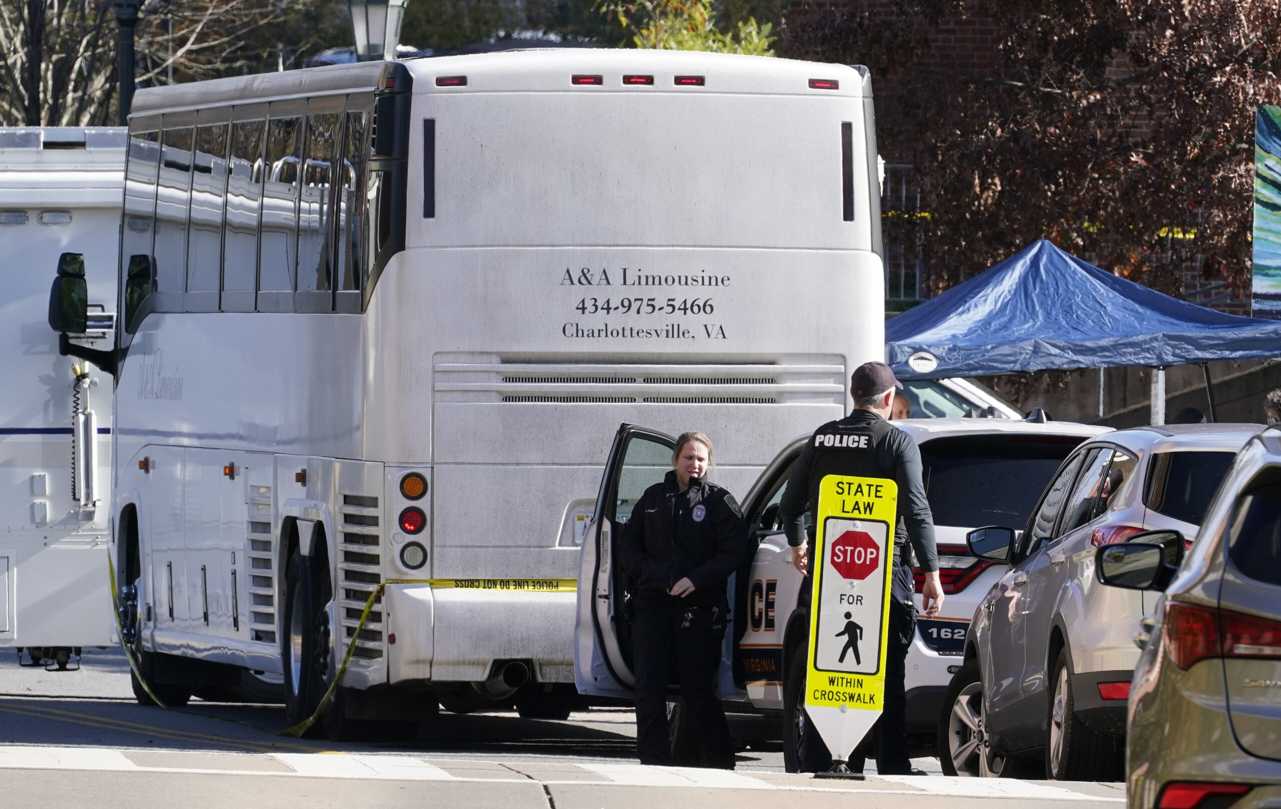 Police investigators work around a bus which is believed to be the site of an overnight shooting