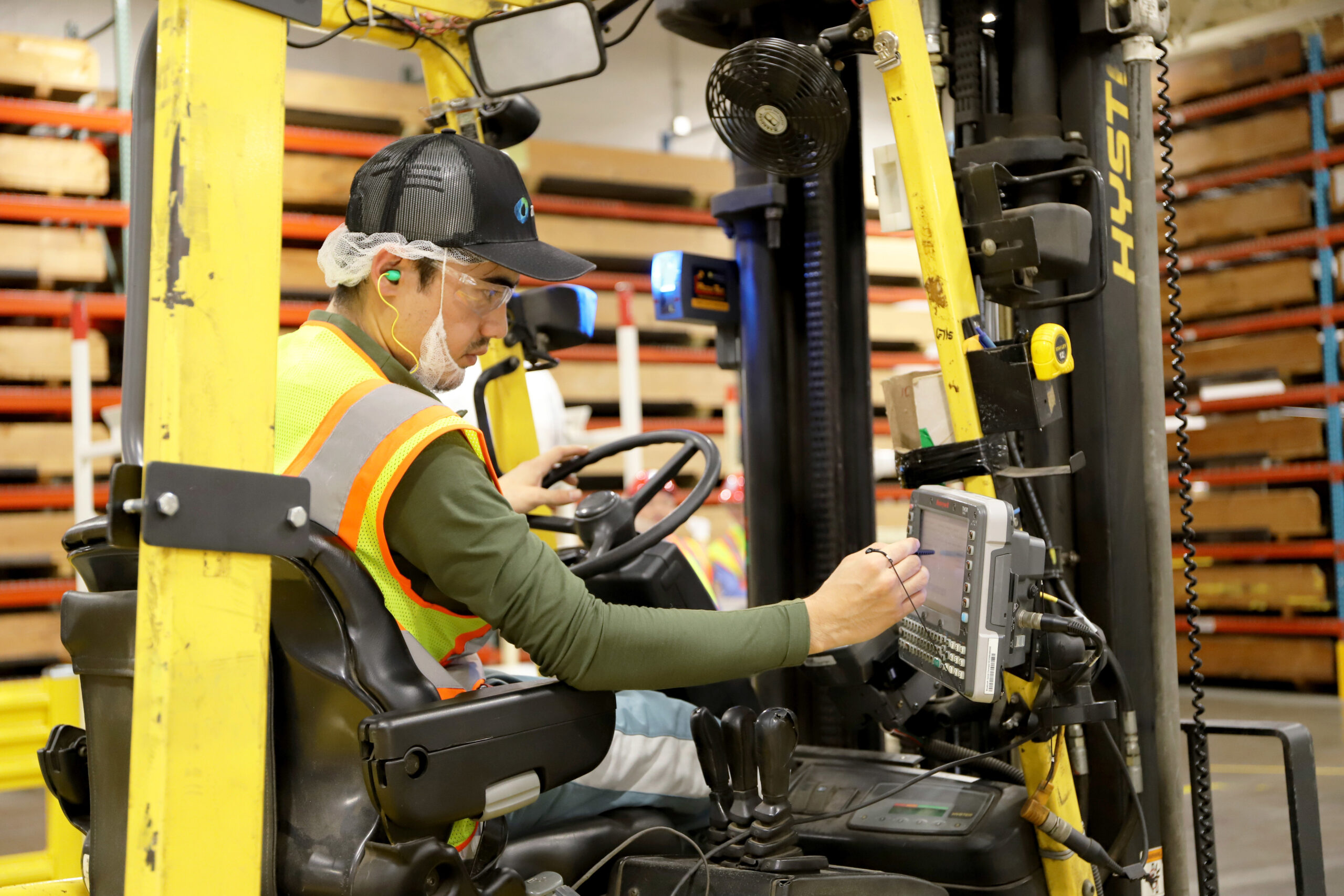 A refugee operates a forklift for a Fox Valley manufacturer.