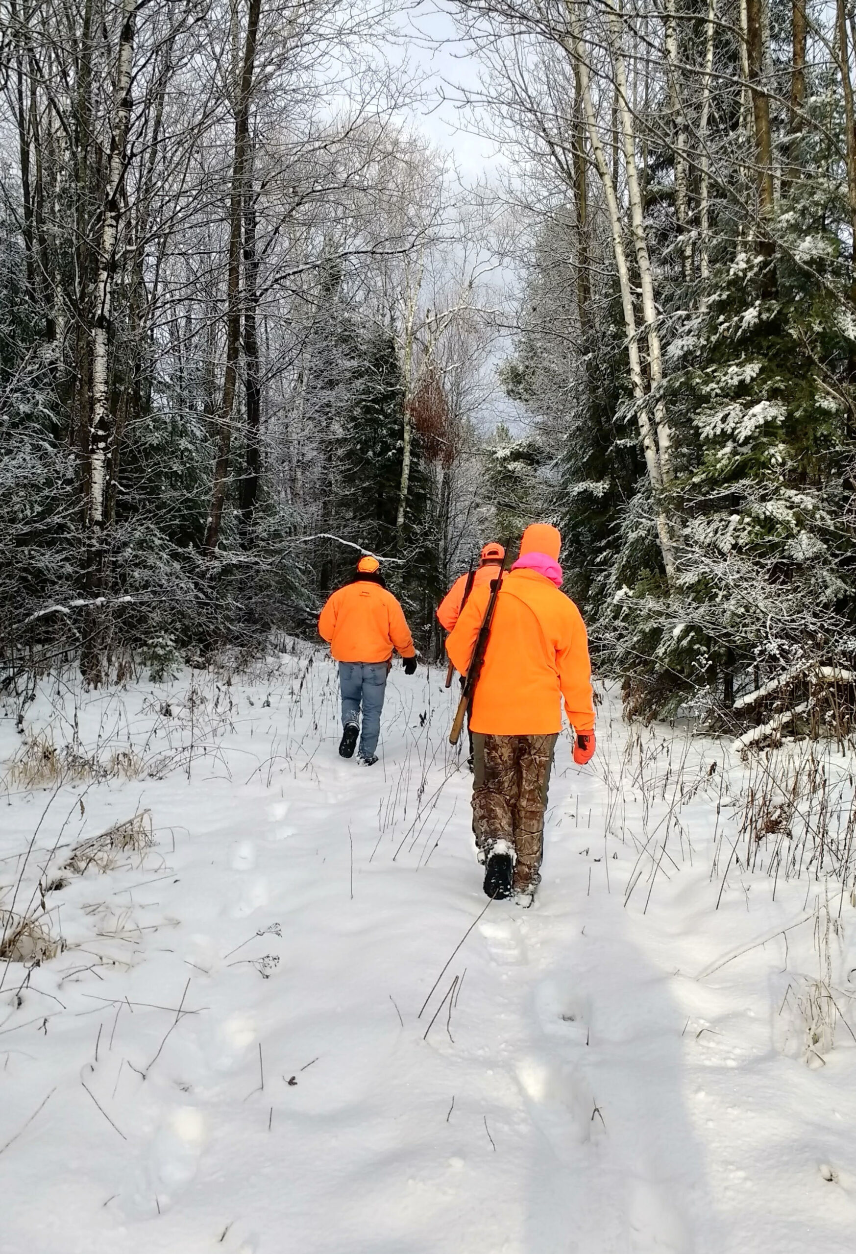 Members of Rebecca Holman's family in blaze orange set up a drive while hunting