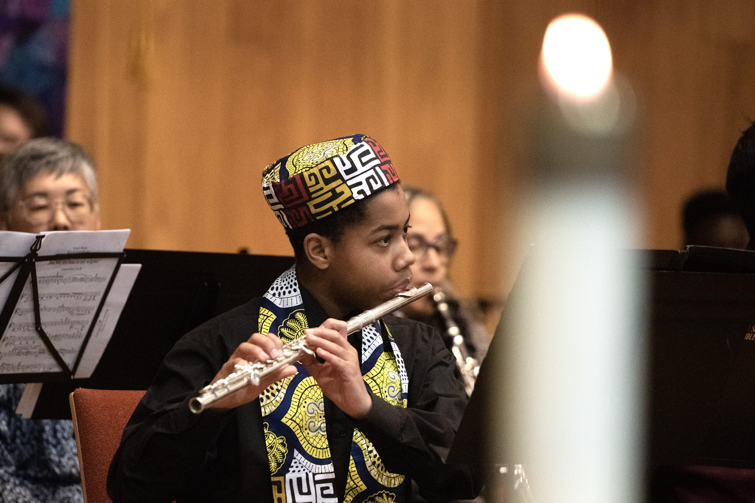 A flautist performs with other musicians.