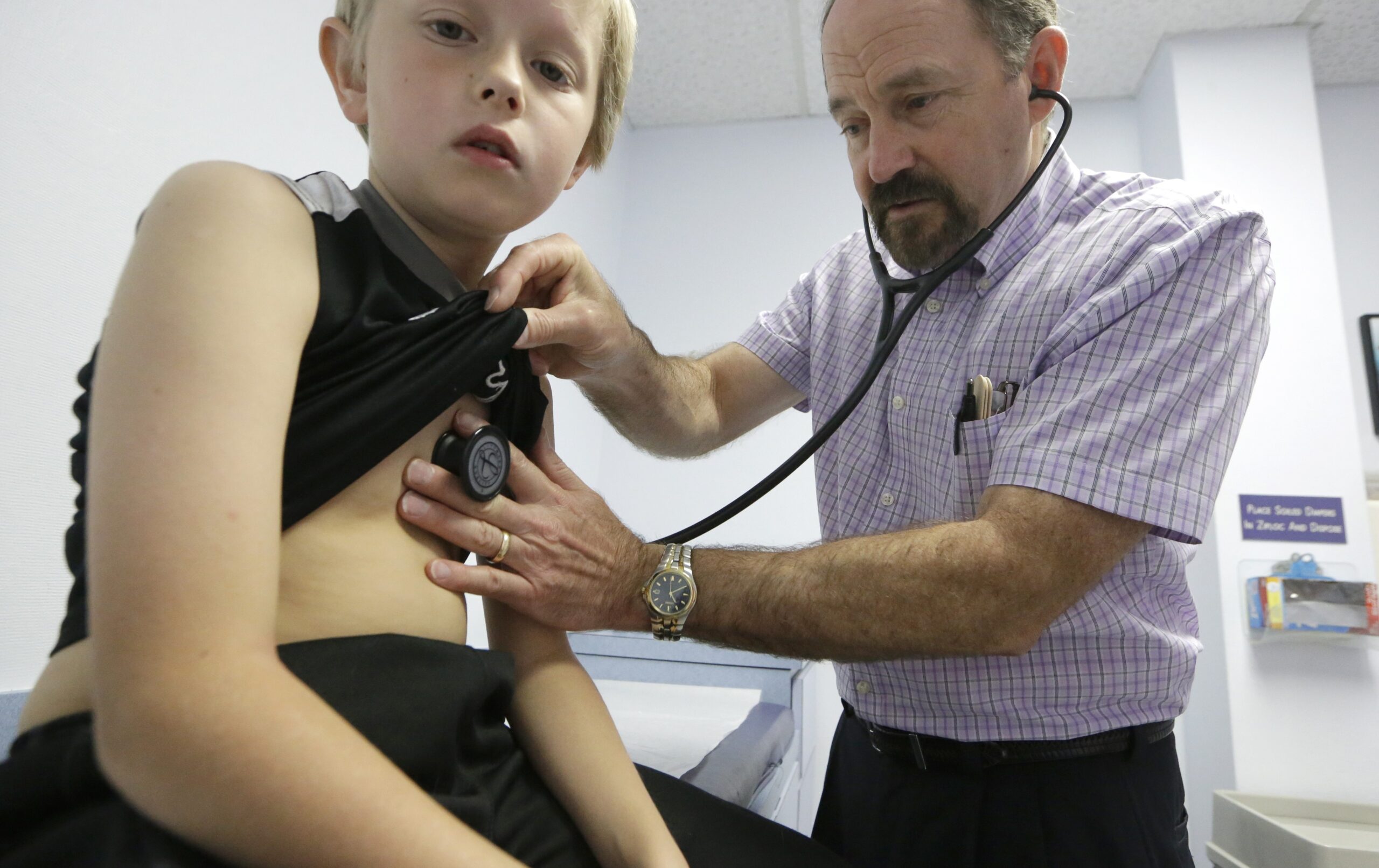 Dr. John Porter examines Connor Russell, 8, during an office visit.