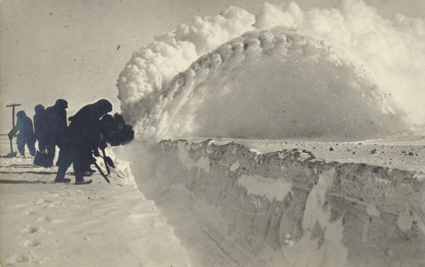 Winter scene with men clearing a pathway through mounds of snow, New Richmond, 1916. Wisconsin Historical Society