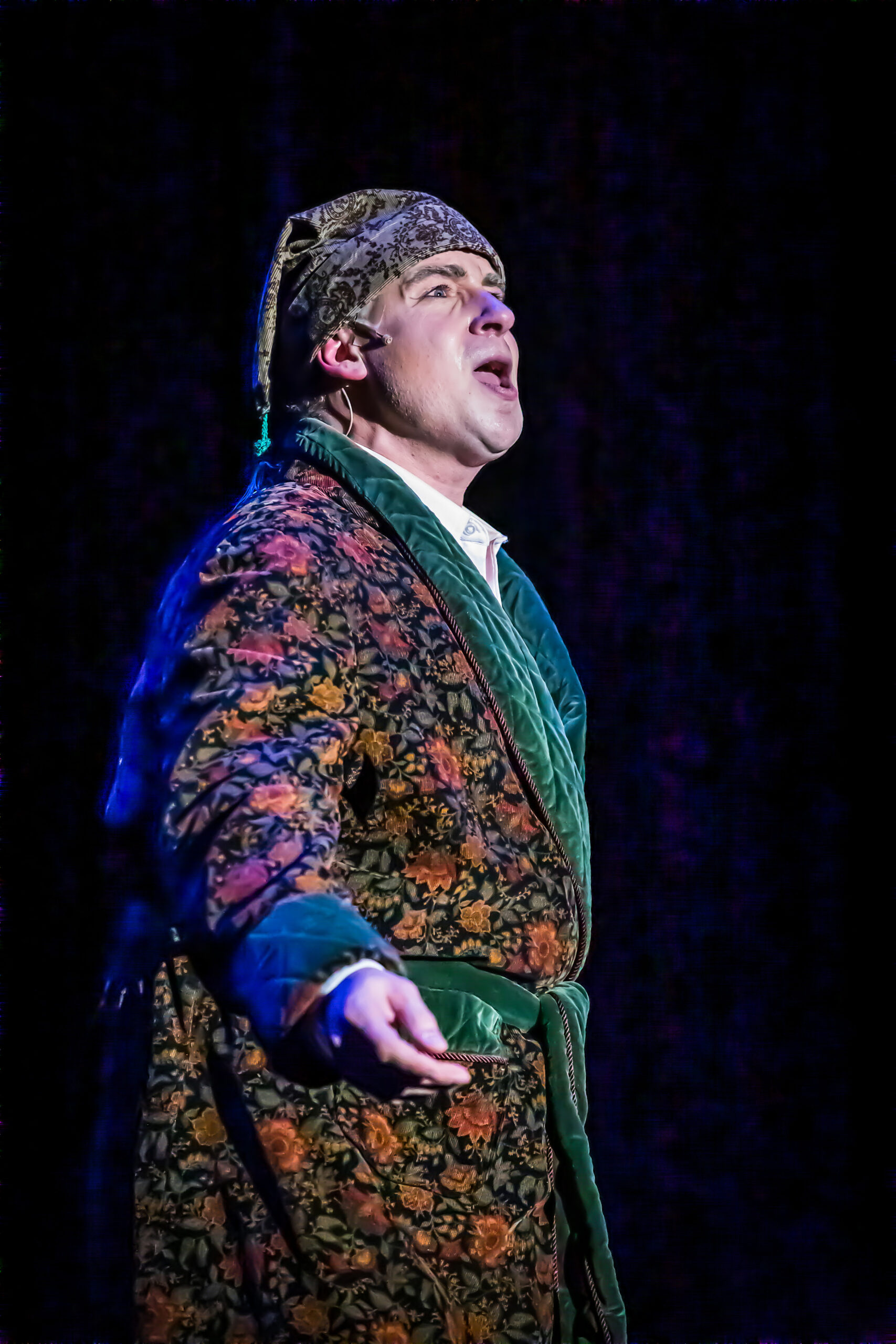 A man playing Ebenezer Scrooge speaks during a performance of A Christmas Carol