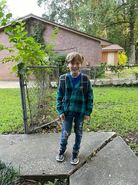 Tamara Loertscher’s son, Harmonious, smiles before his first day of second grade earlier in 2022