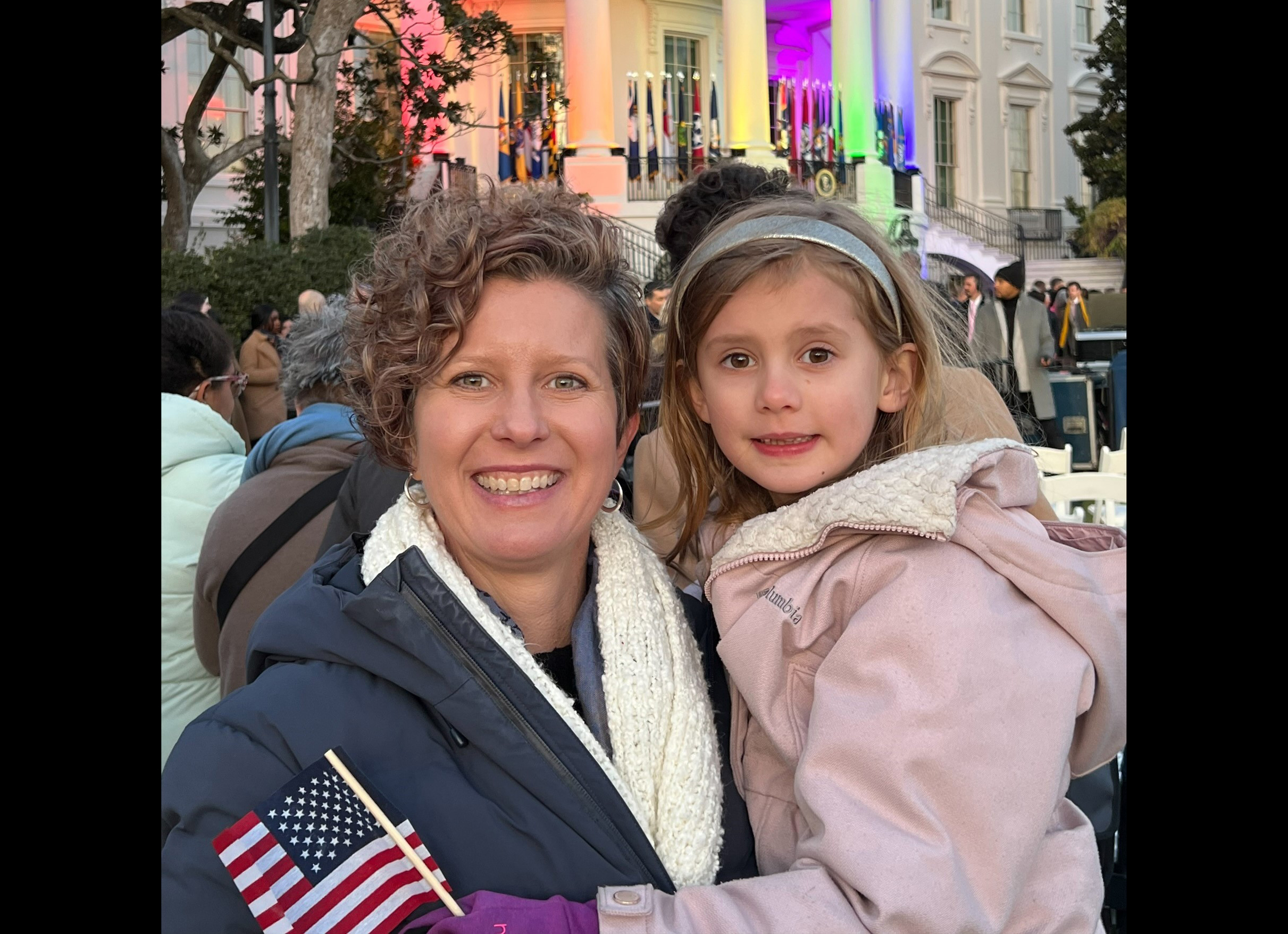 Shelbi Day holds her daughter in front of the White House