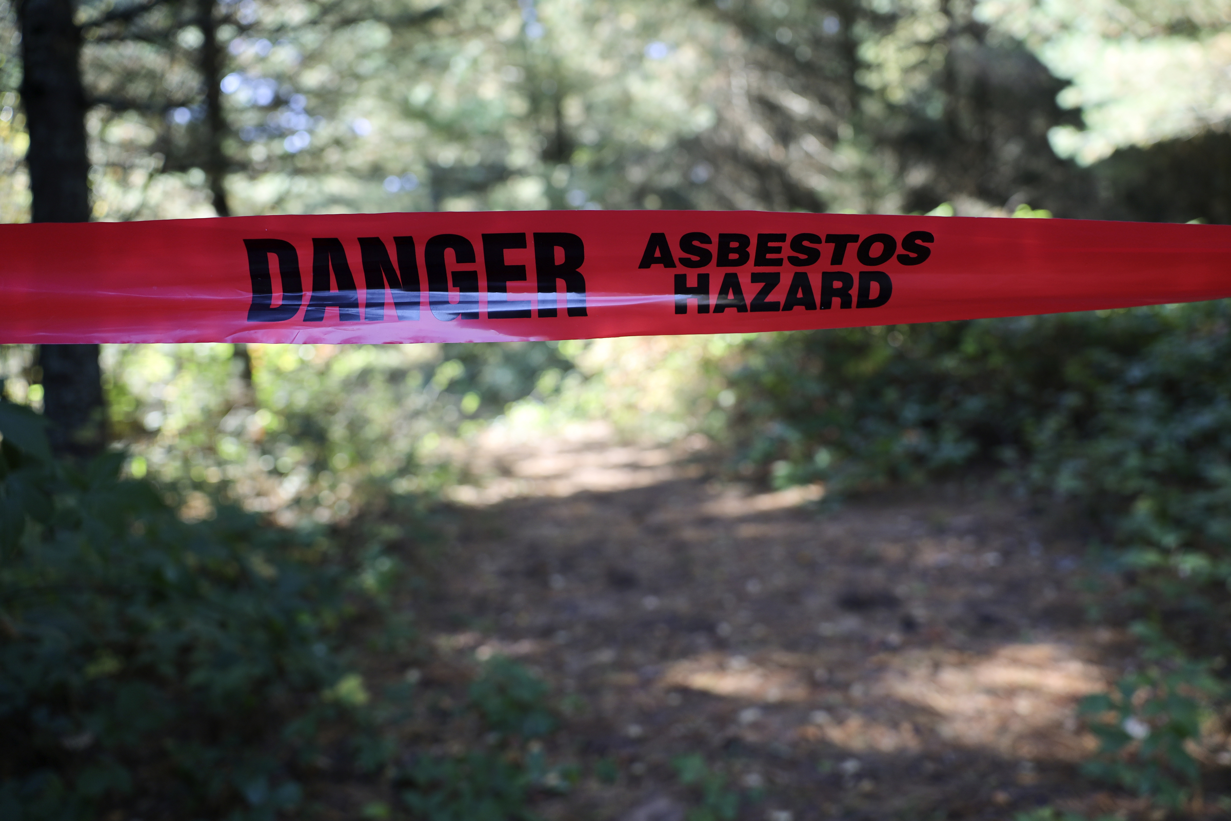 Red caution tape on Zach Skrede's property says 'Danger Asbestos Hazard'