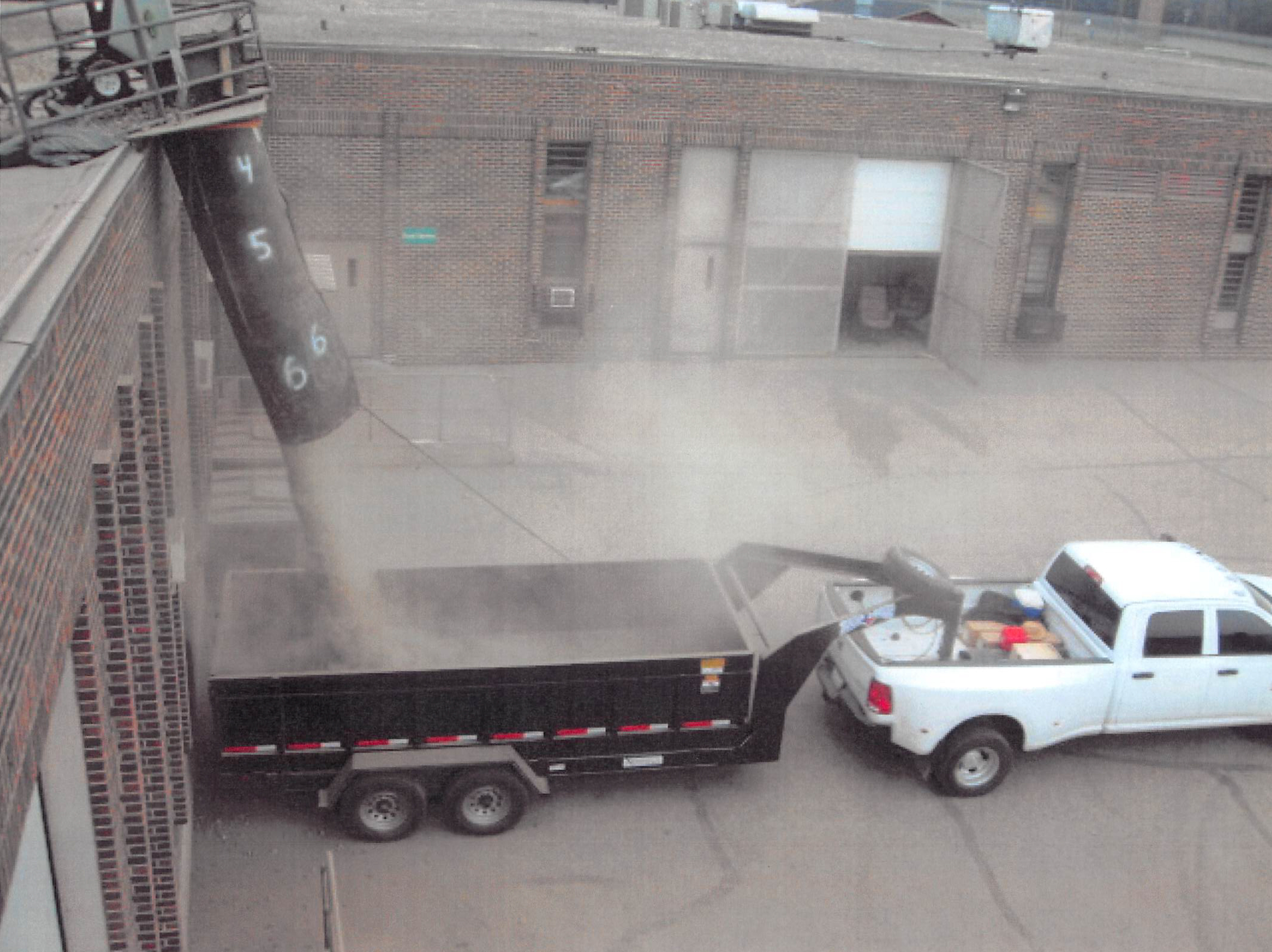 Brazos Urethane, Inc., employees pour material down a chute during a 2015 roofing project