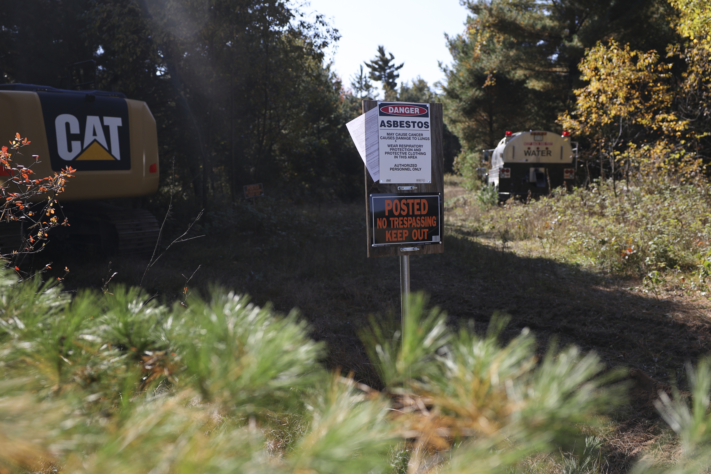 A sign on Zach Skrede’s property in the town of Easton in Adams County, Wis., warns about the presence of asbestos