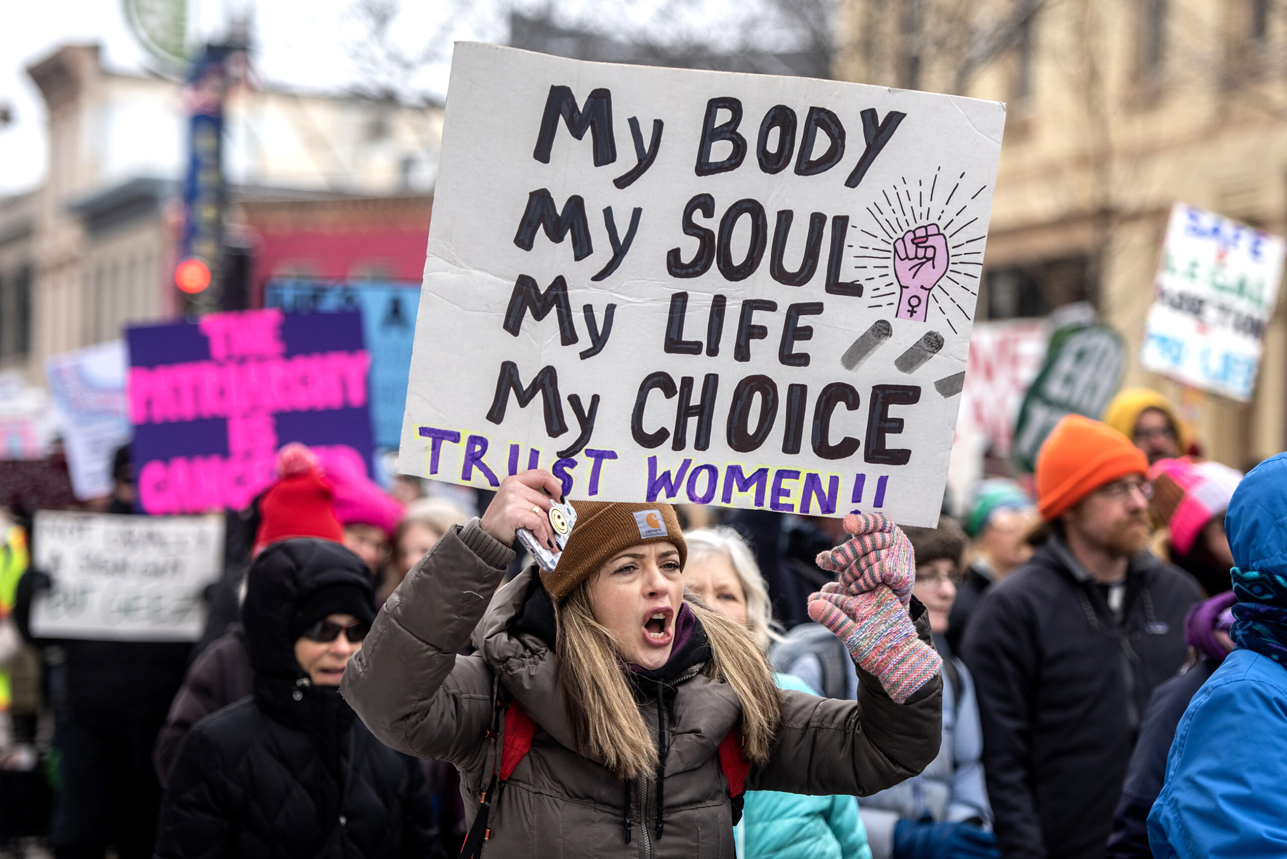 A protester's sign says 