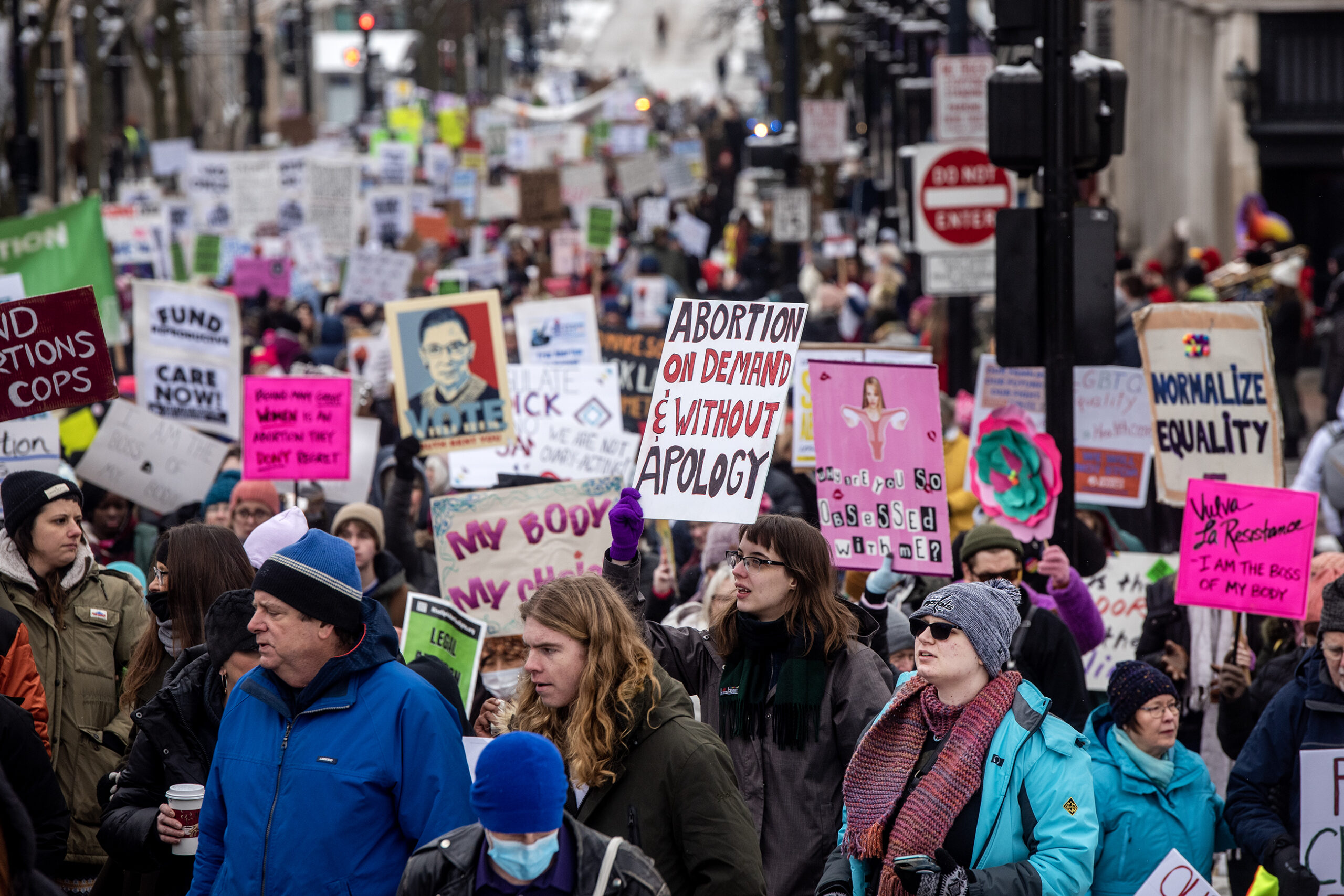 Protesters fill State Street and hold up signs.