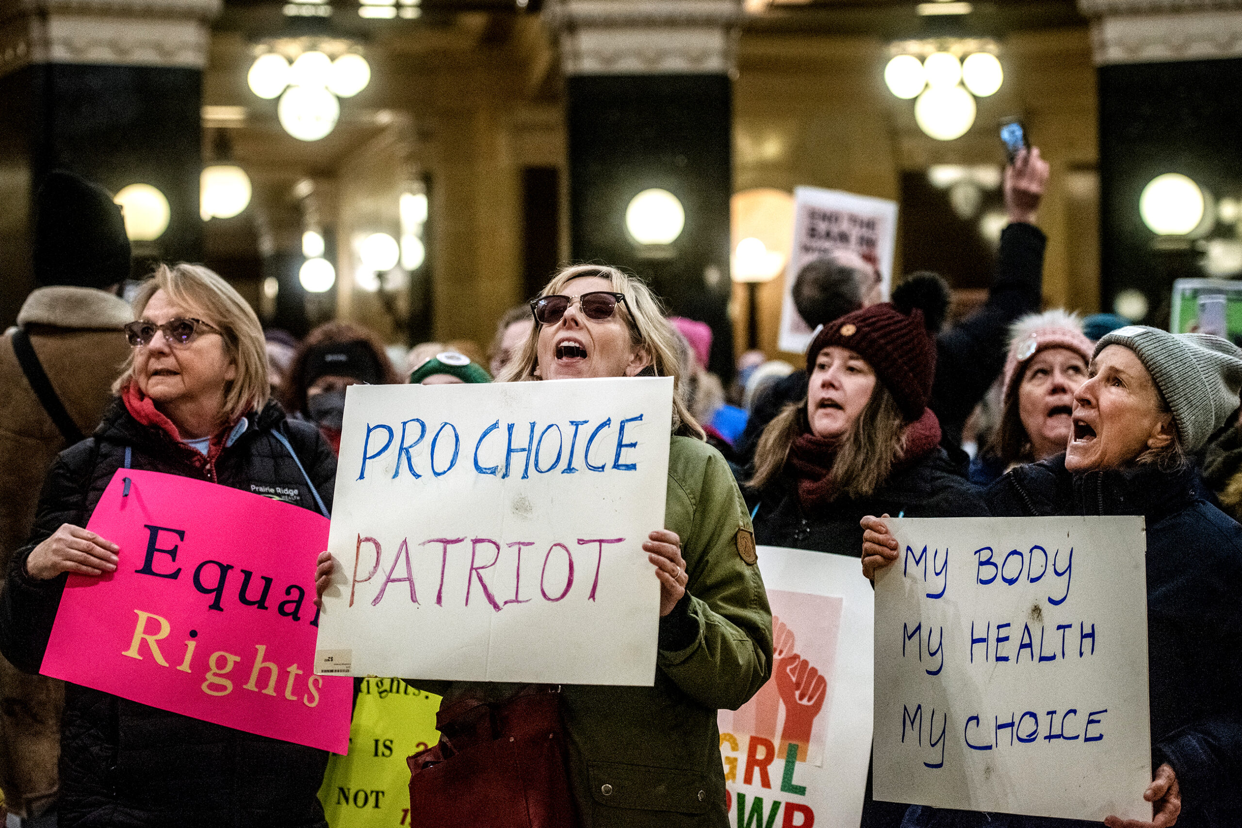 A woman holds a sign that says 