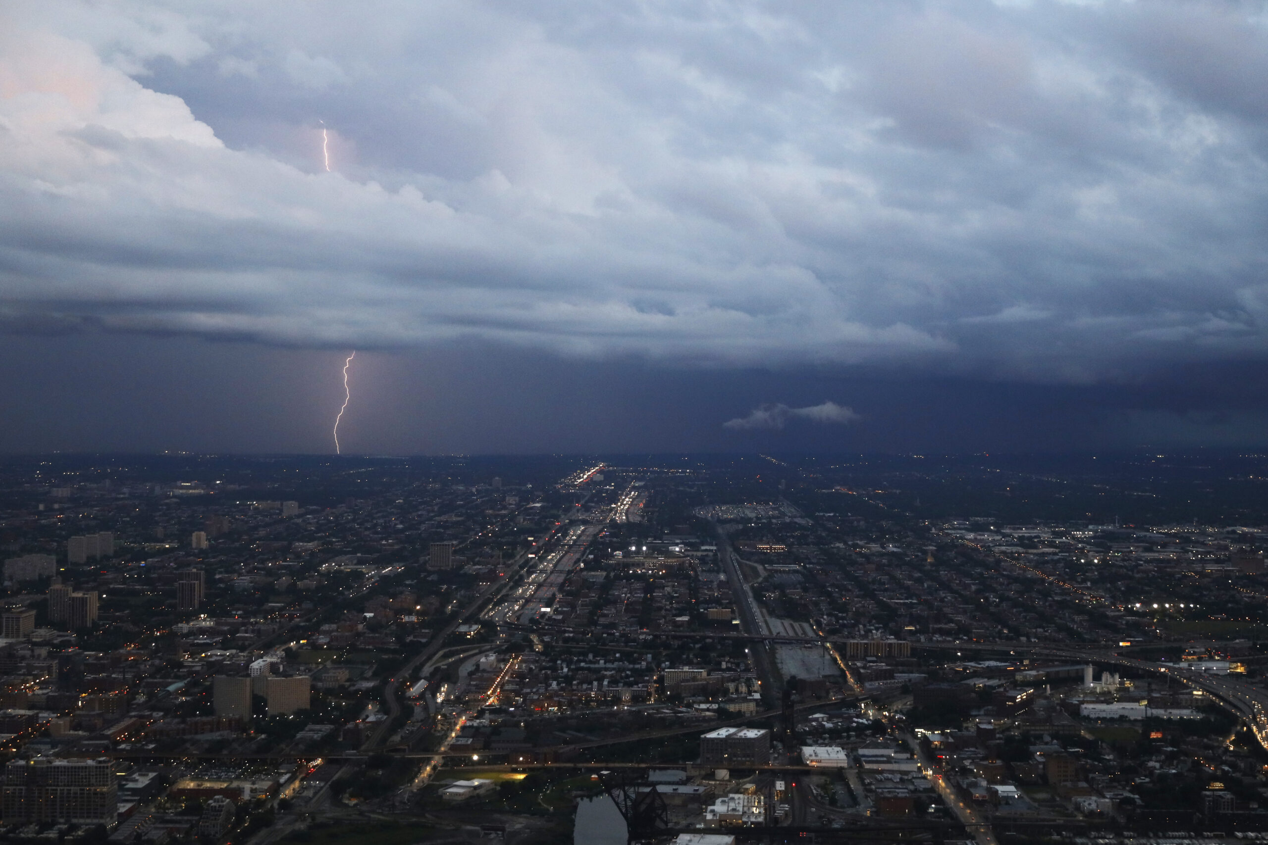 An aerial shot shows a bolt of lightning touching ground in Chicago