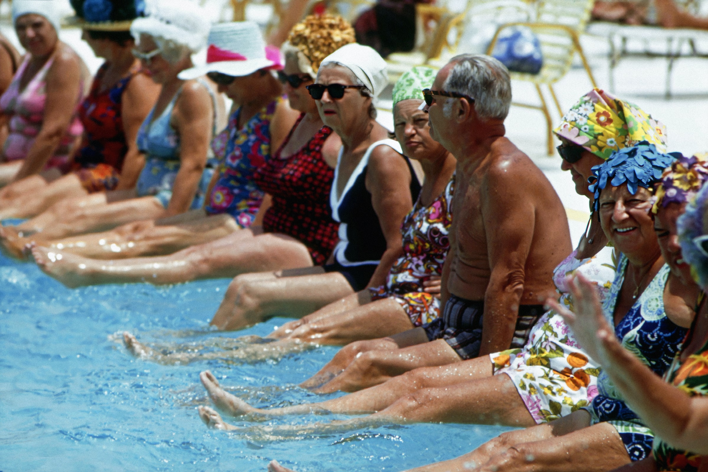People exercising on the side of a swimming pool