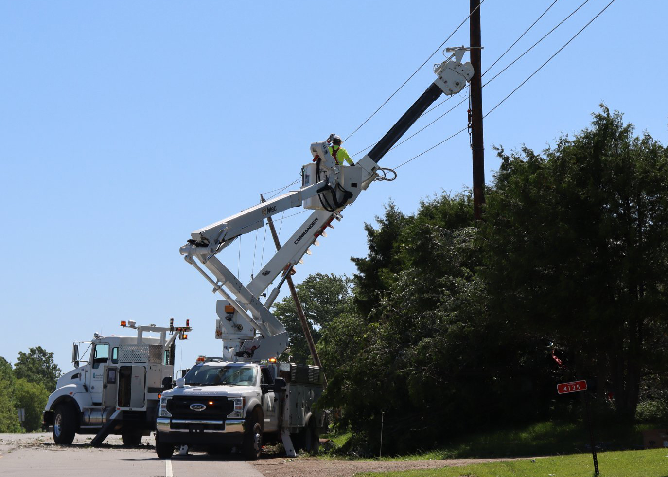 An Oconto Electric Cooperative truck works on a downed power line last summer.