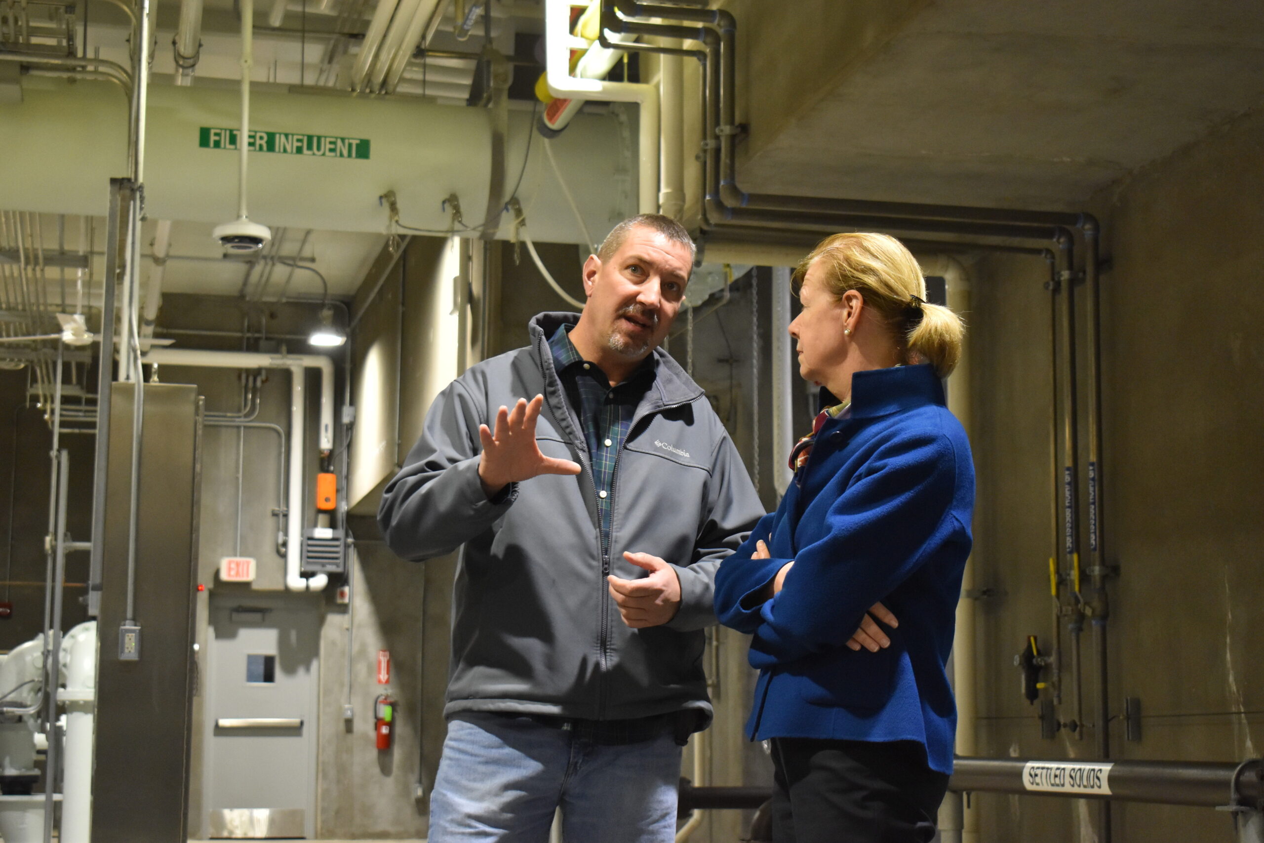 Wausau drinking water superintendent Scott Boers speaks with U.S. Sen. Tammy Baldwin during a tour and press conference at Wausau's newly opened water treatment facility