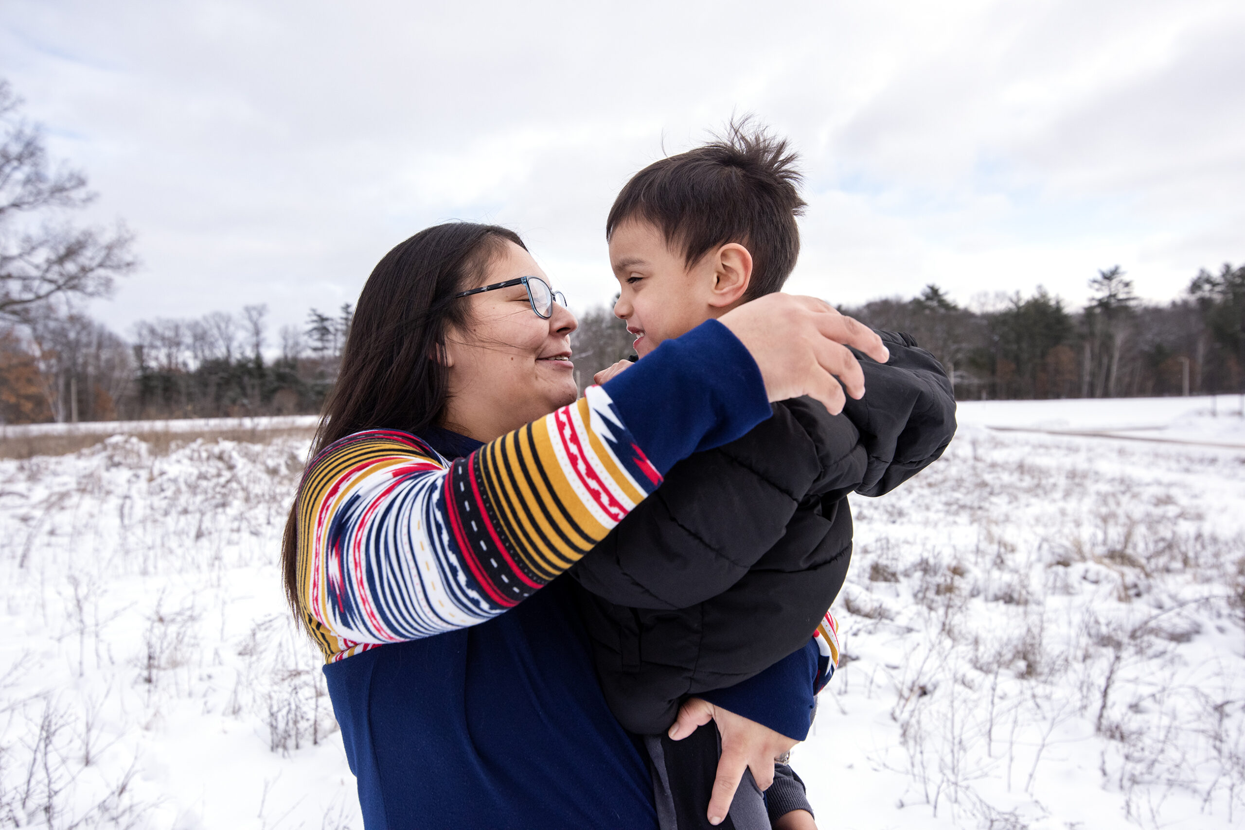 Lydi Dodge holds a small boy in her arms.