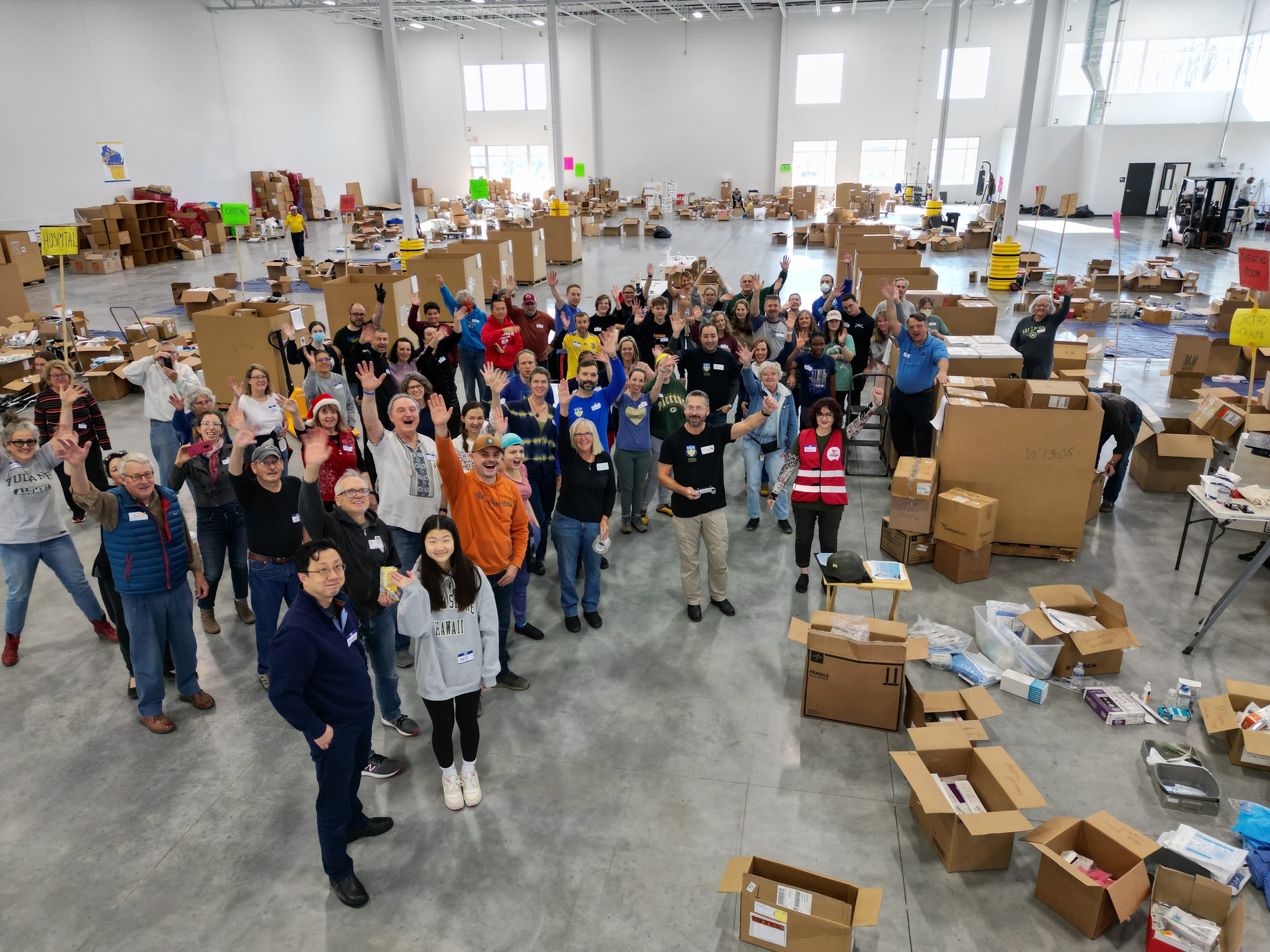 Volunteers with UMANA Illinois Chapter in Wisconsin work at a Germantown warehouse to pack medical aid supplies