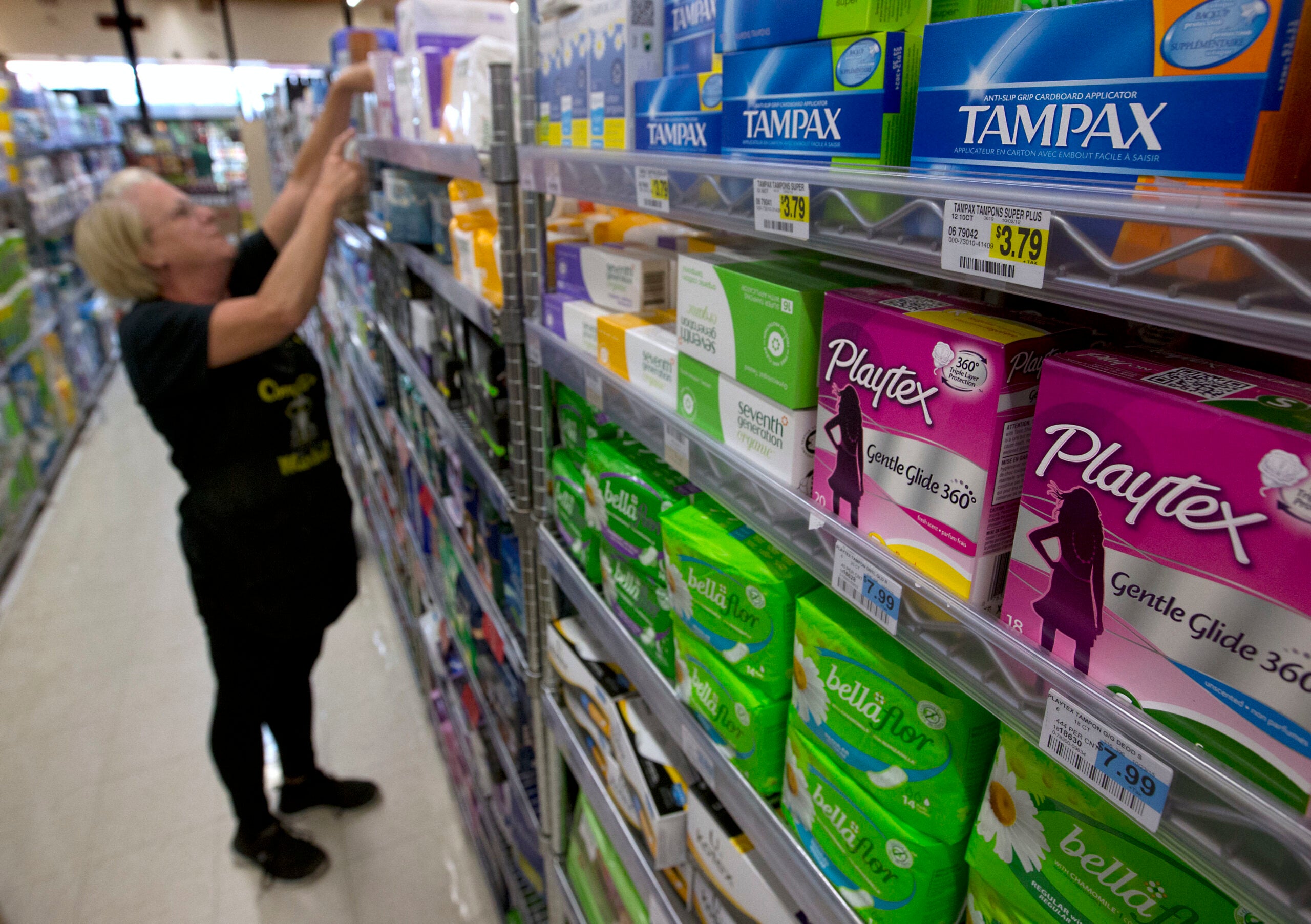 Tammy Compton restocks tampons at Compton's Market.