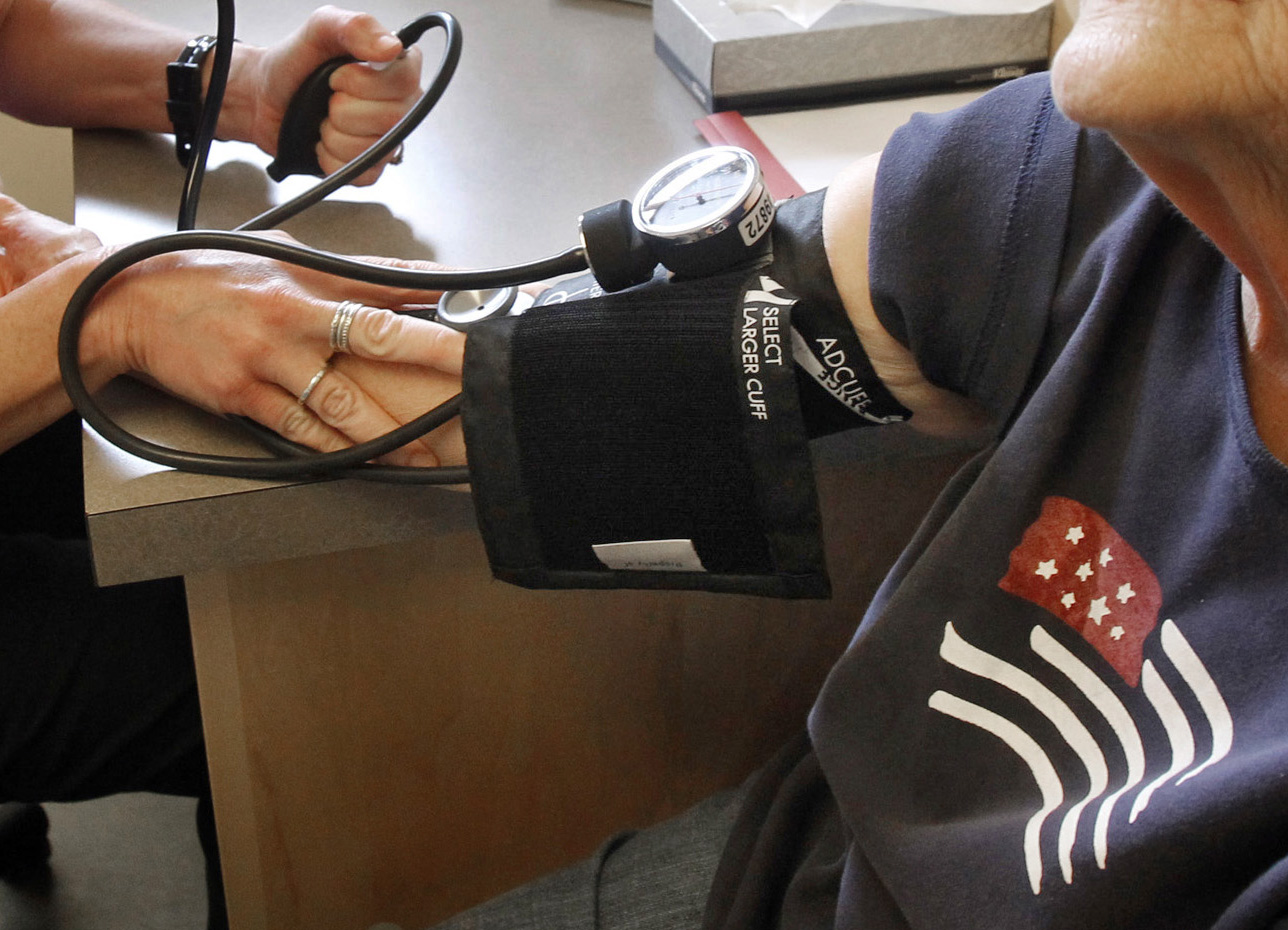 A patient has her blood pressure checked.