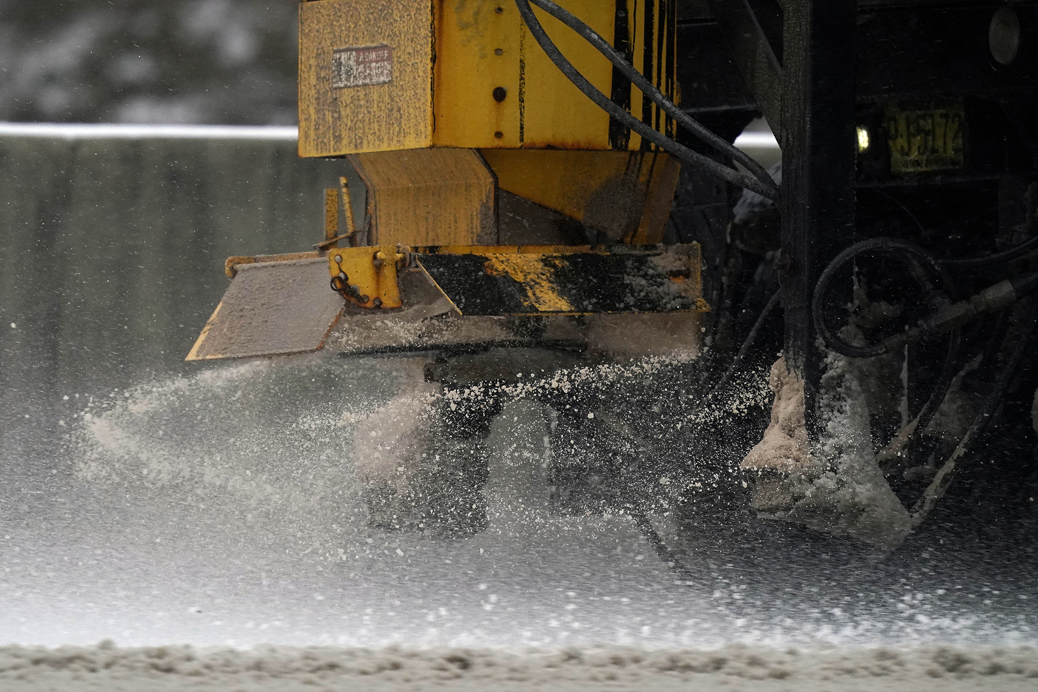 A salt truck spreads brine on the road.