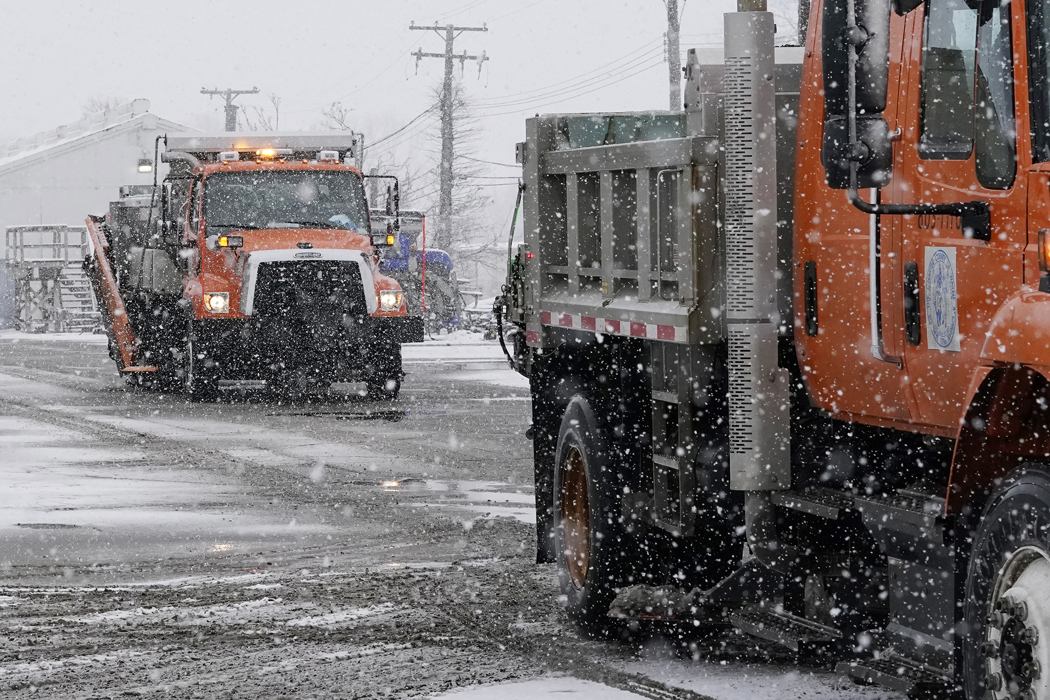 Salt trucks leave the Wayne County Department of Public Services.
