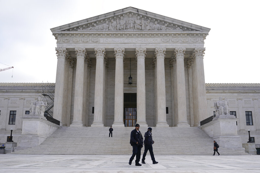 Police officers walk outside the Supreme Court on Capitol Hill in Washington.