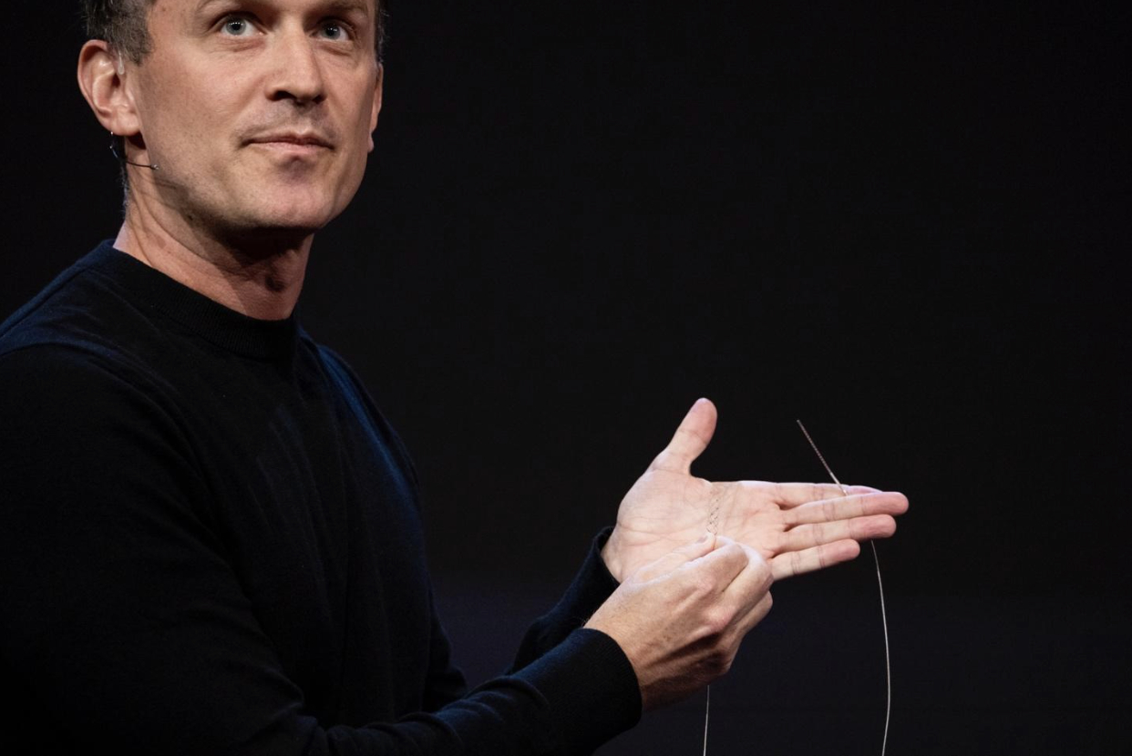 A man holds a medical device that doctors would implant in a patient's brain by going through their veins