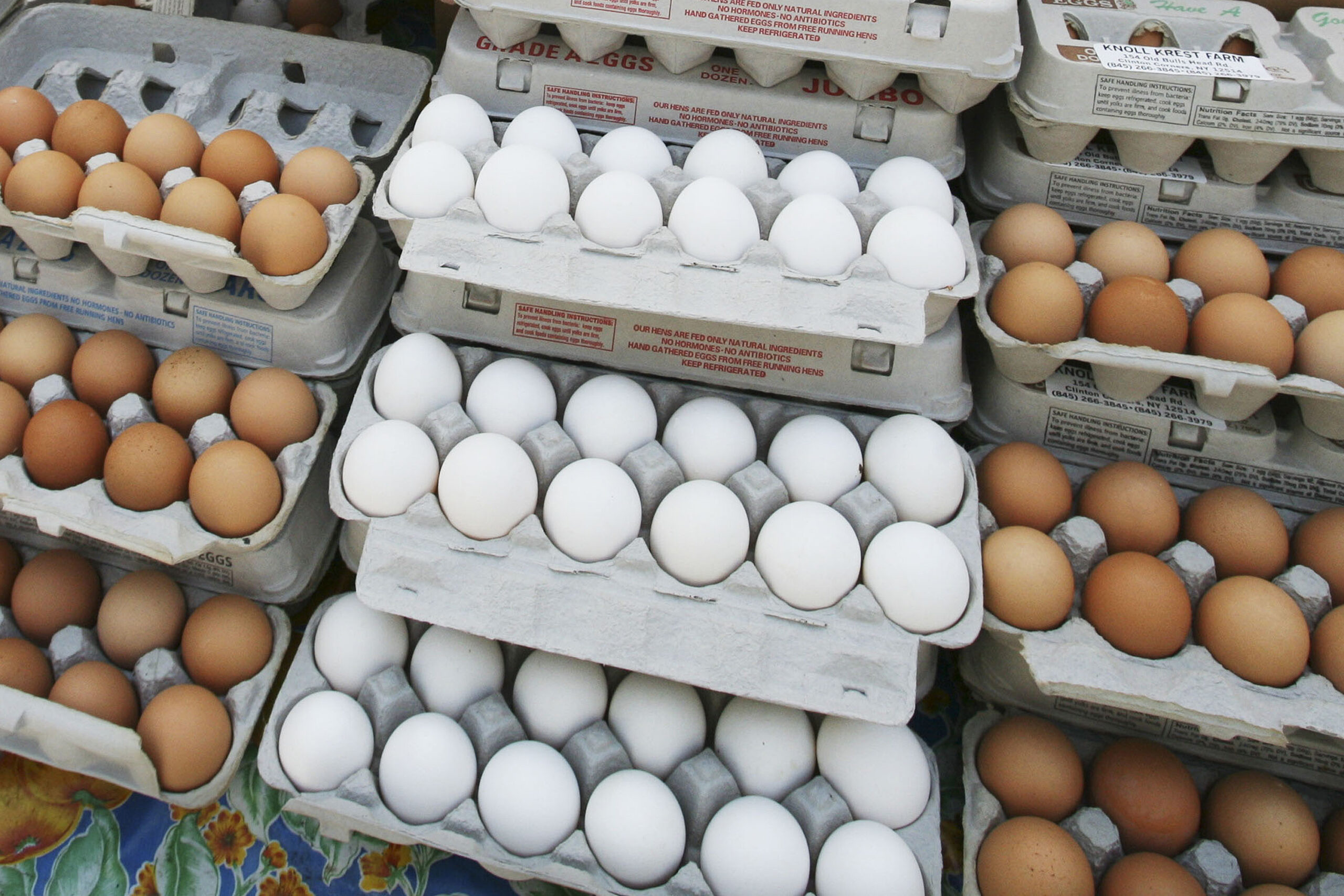 Cartons of eggs are displayed for sale.