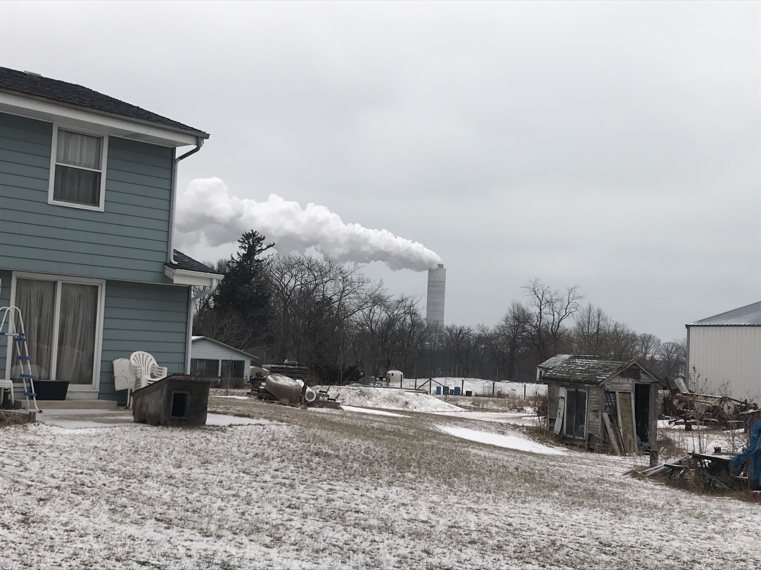 A power plant releases steam and smoke near homes in Oak Creek