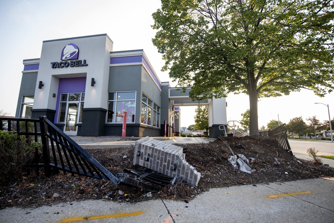 A Taco Bell at the corner of Milwaukee’s West Fond du Lac Avenue and West Congress Street is surrounded by a fence that was damaged during a fatal crash in Milwaukee