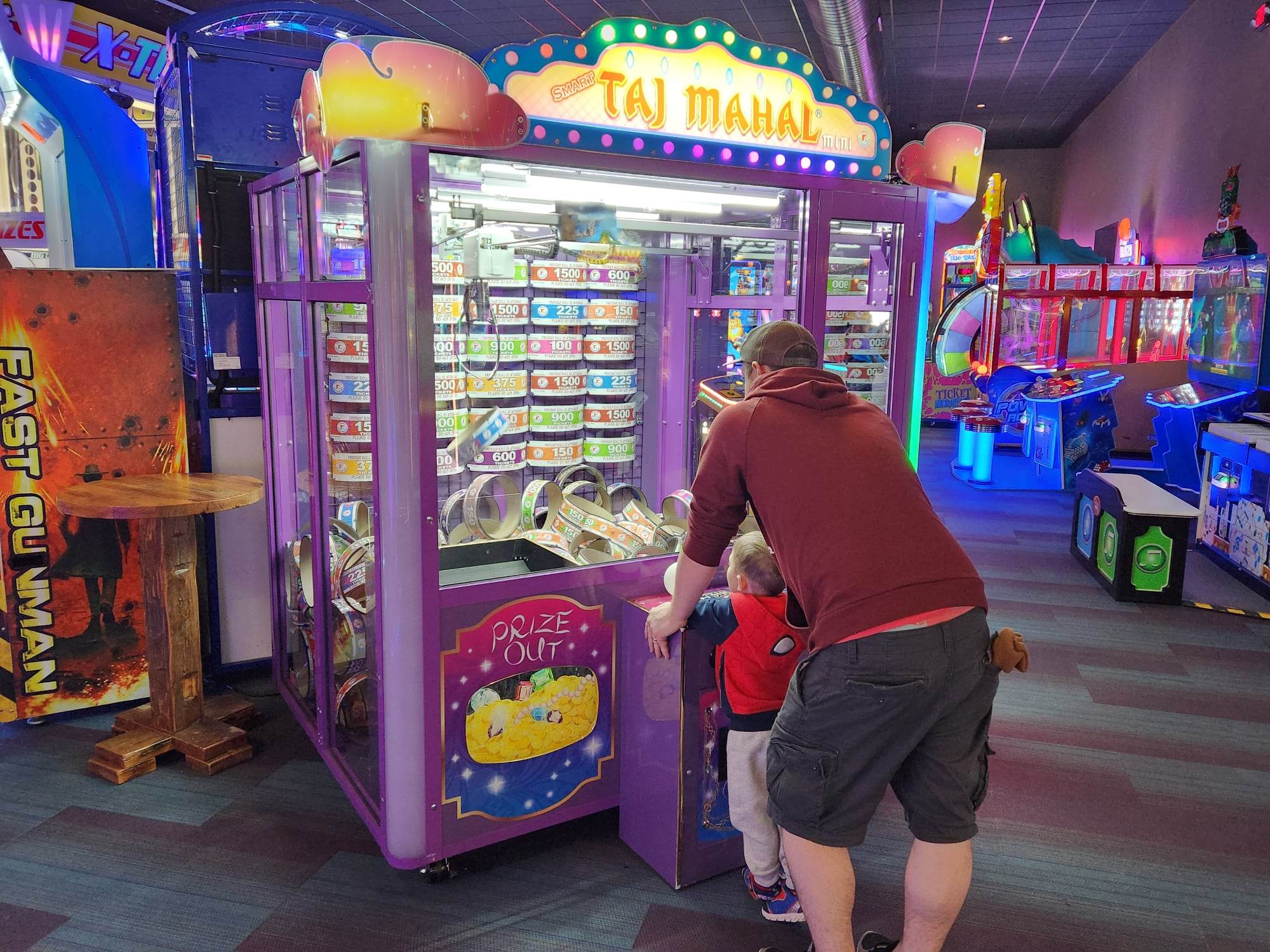 Luke Ebert helps his son Owen play the claw machine at the Mineshaft in Oshkosh.