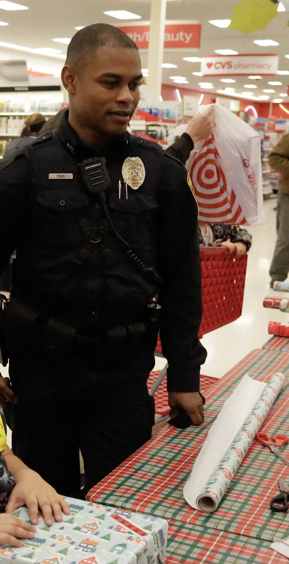 Sheboygan police officer Bryan Pray, right, is seen at Target during the department’s Shop with a Cop program