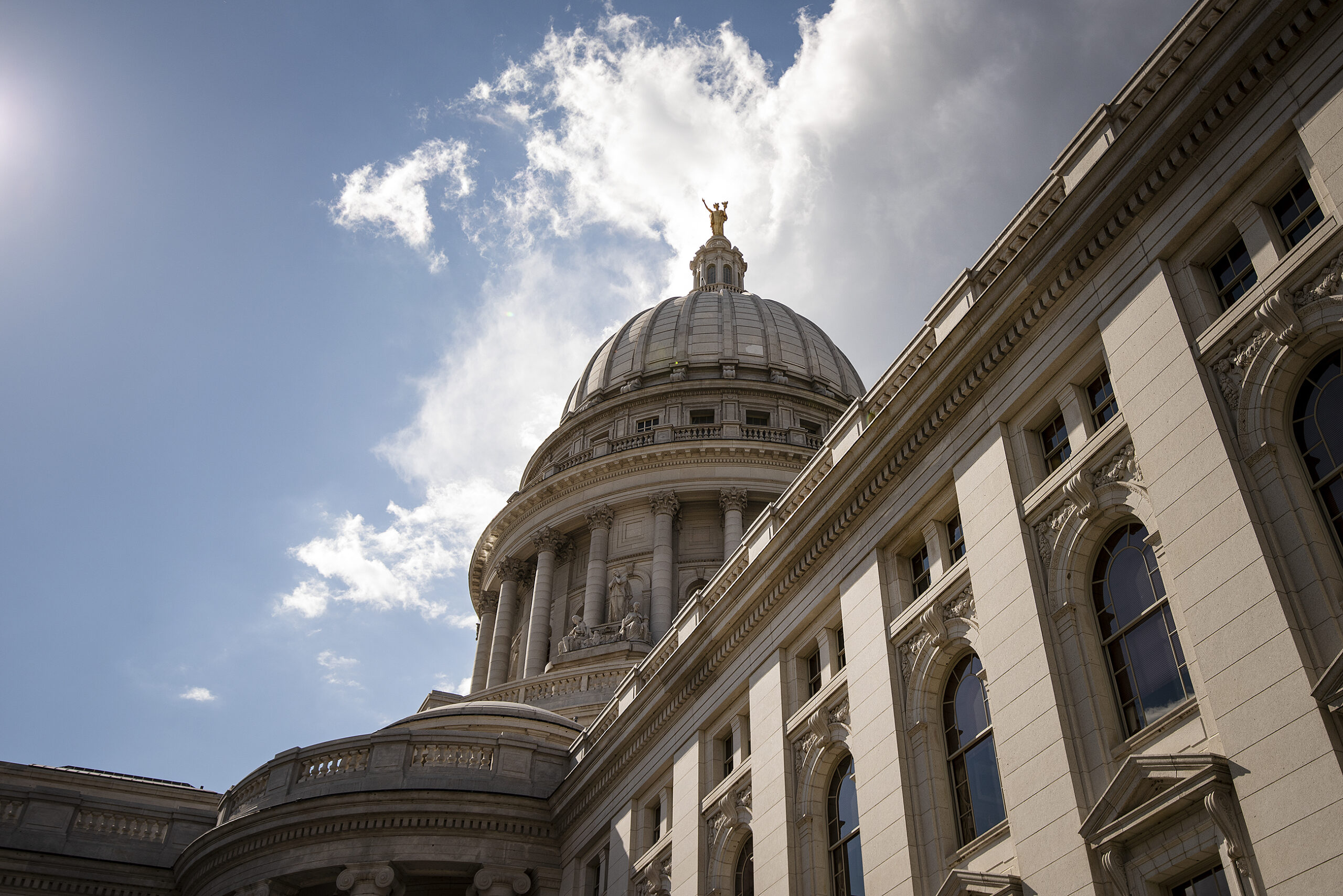 Clouds and a blue sky are the backdrop for the Wisconsin State Capitol