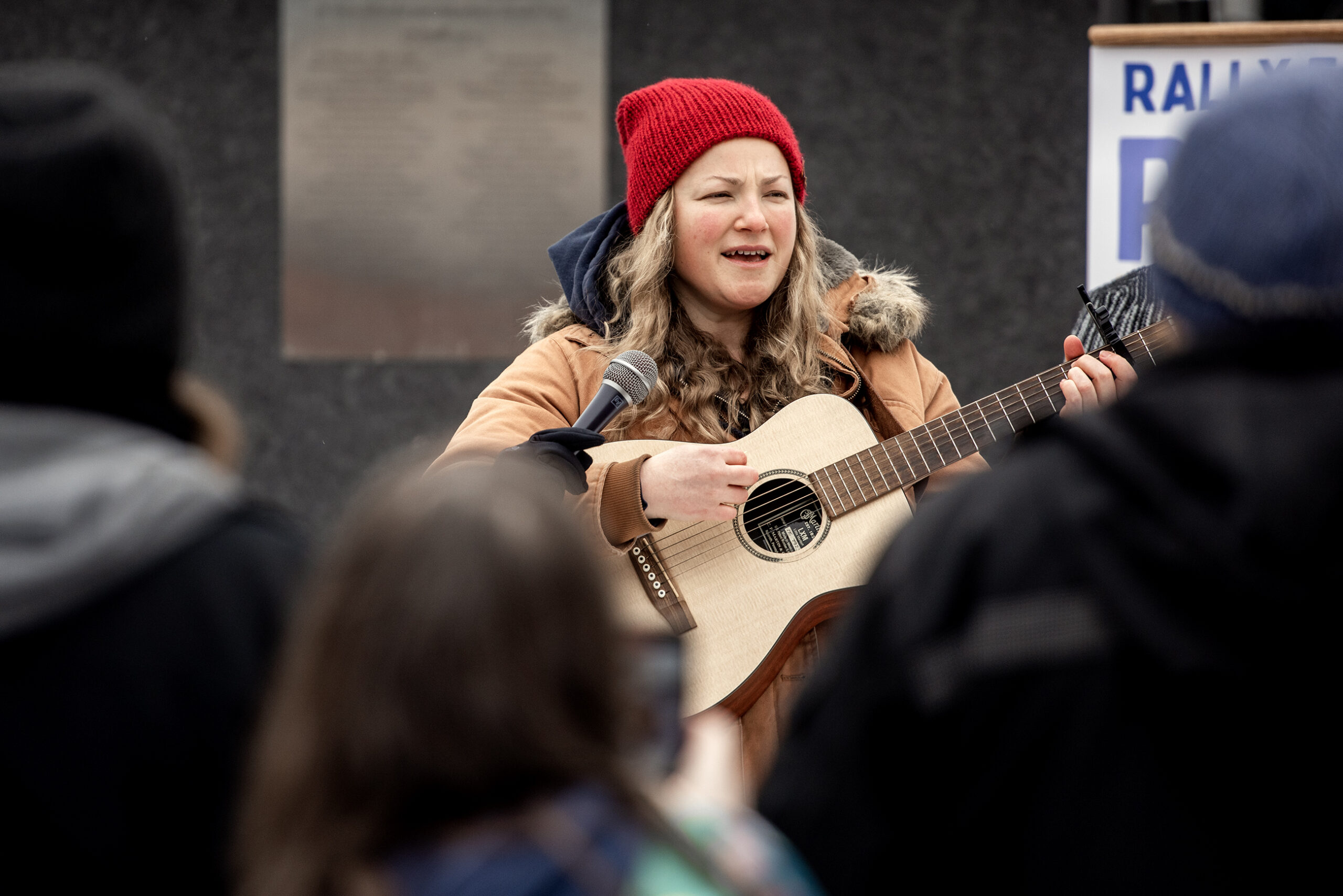 A woman plays the guitar.