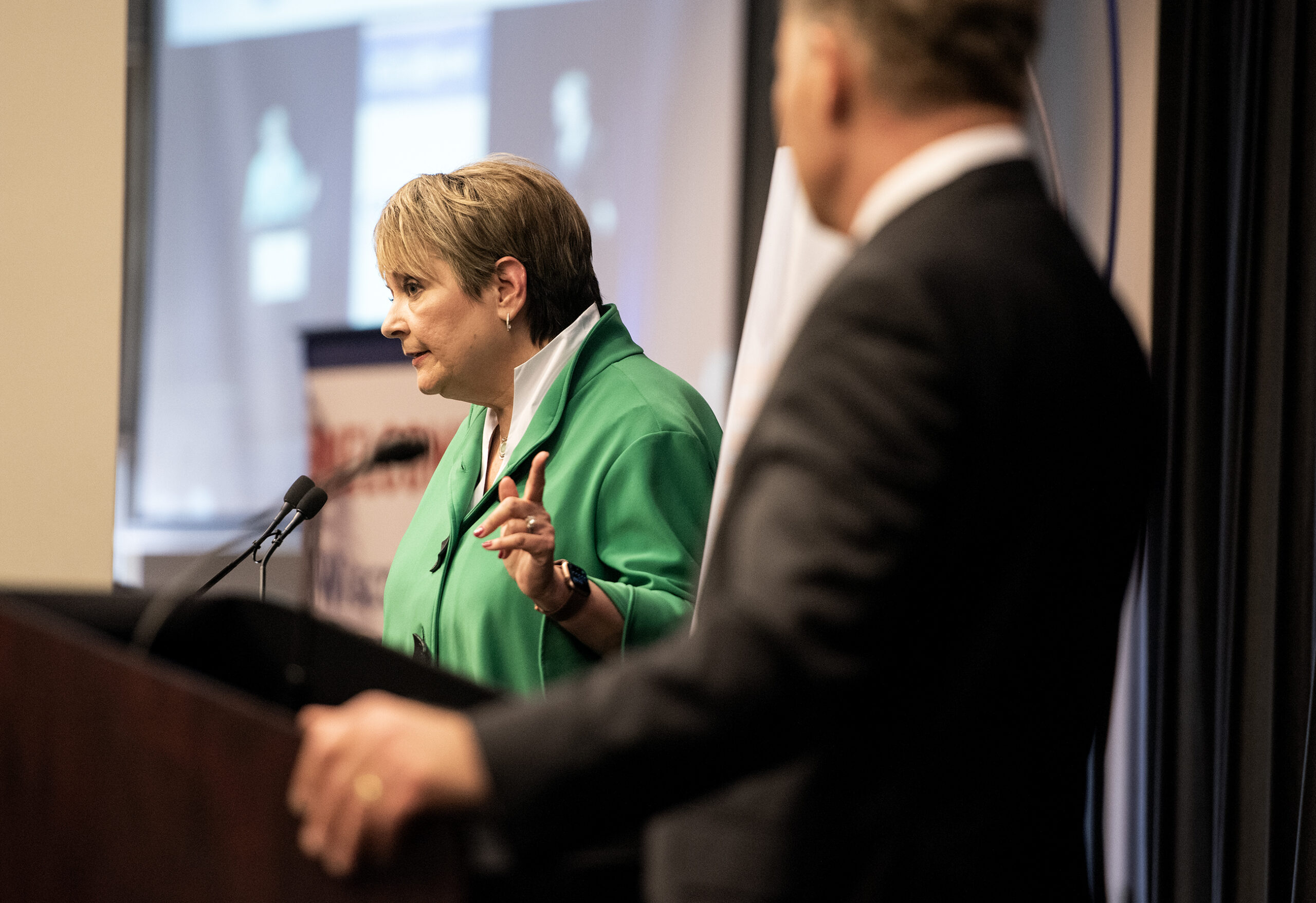 Janet Protasiewicz points at Dan Kelly as they debate on stage.