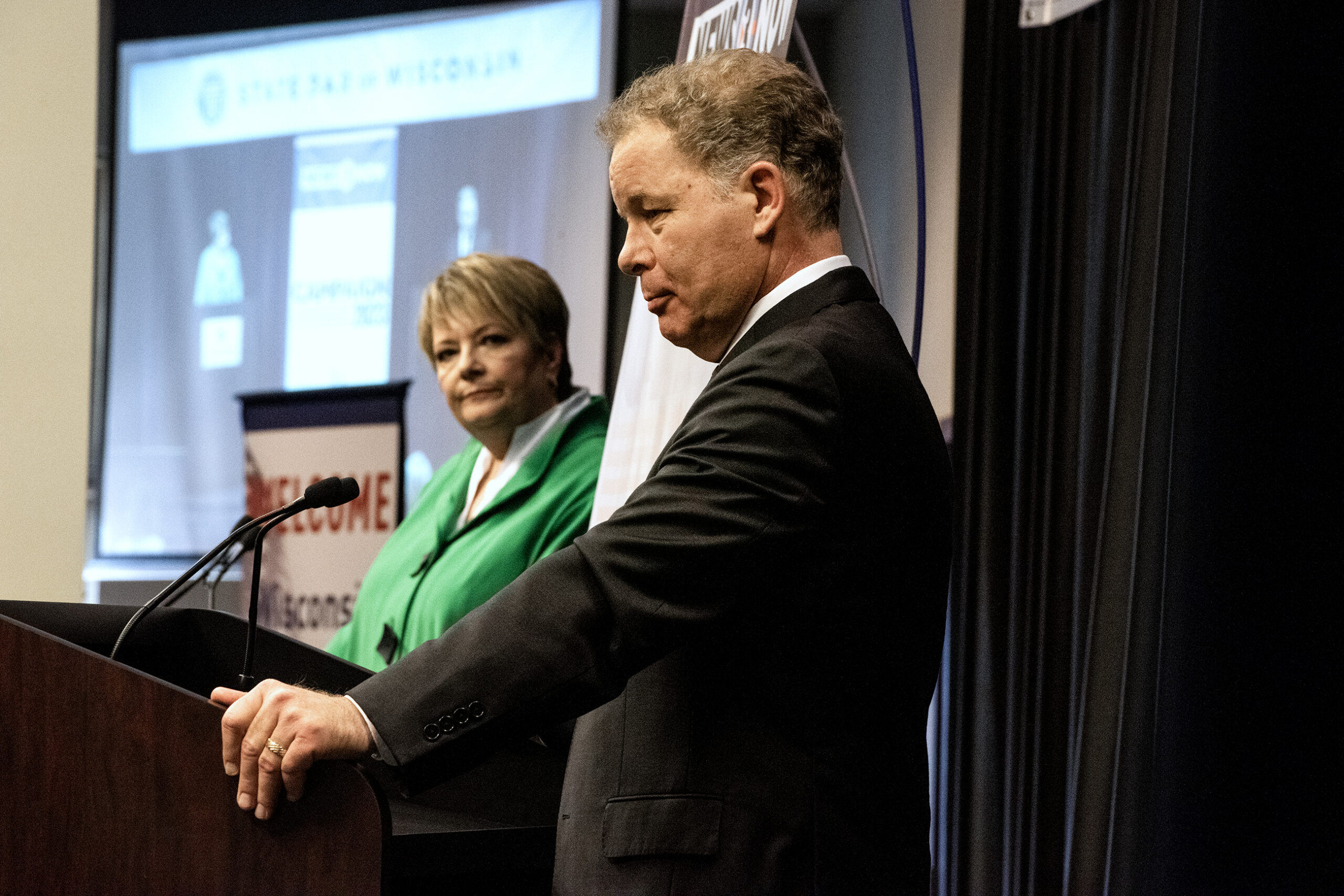 The two candidates are seen on stage during a debate.