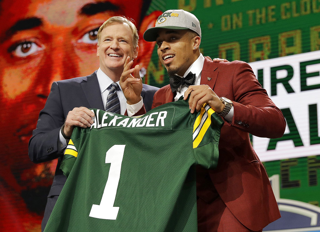 NFL Commissioner Roger Goodell, left, presents Jaire Alexander with his Green Bay Packers jersey during the first round of the 2018 NFL football draft