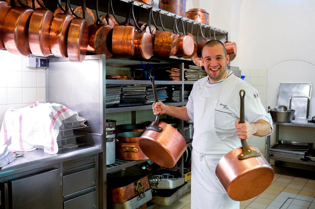 In this Oct. 31 2013 file photo, Guillaume Gomez, the head chef at the Elysee Palace, poses for photographers in the kitchens at the Elysee Palace in Paris.