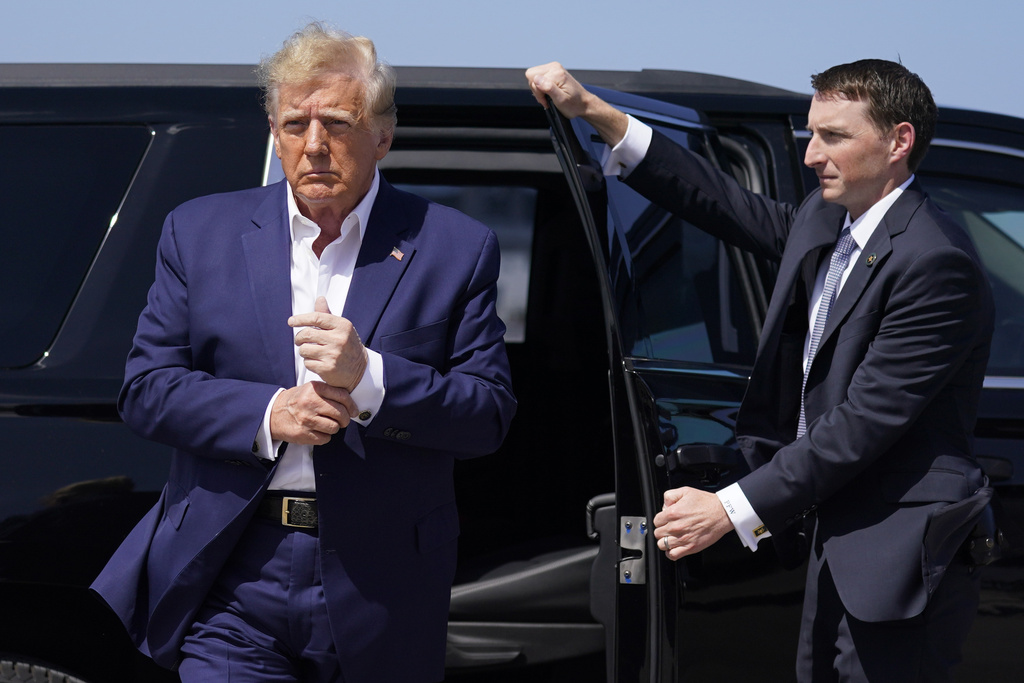 Former President Donald Trump arrives to board his airplane for a trip to a campaign rally in Waco, Texas, at West Palm Beach International Airport in West Palm Beach, Fla, Saturday, March 25, 2023
