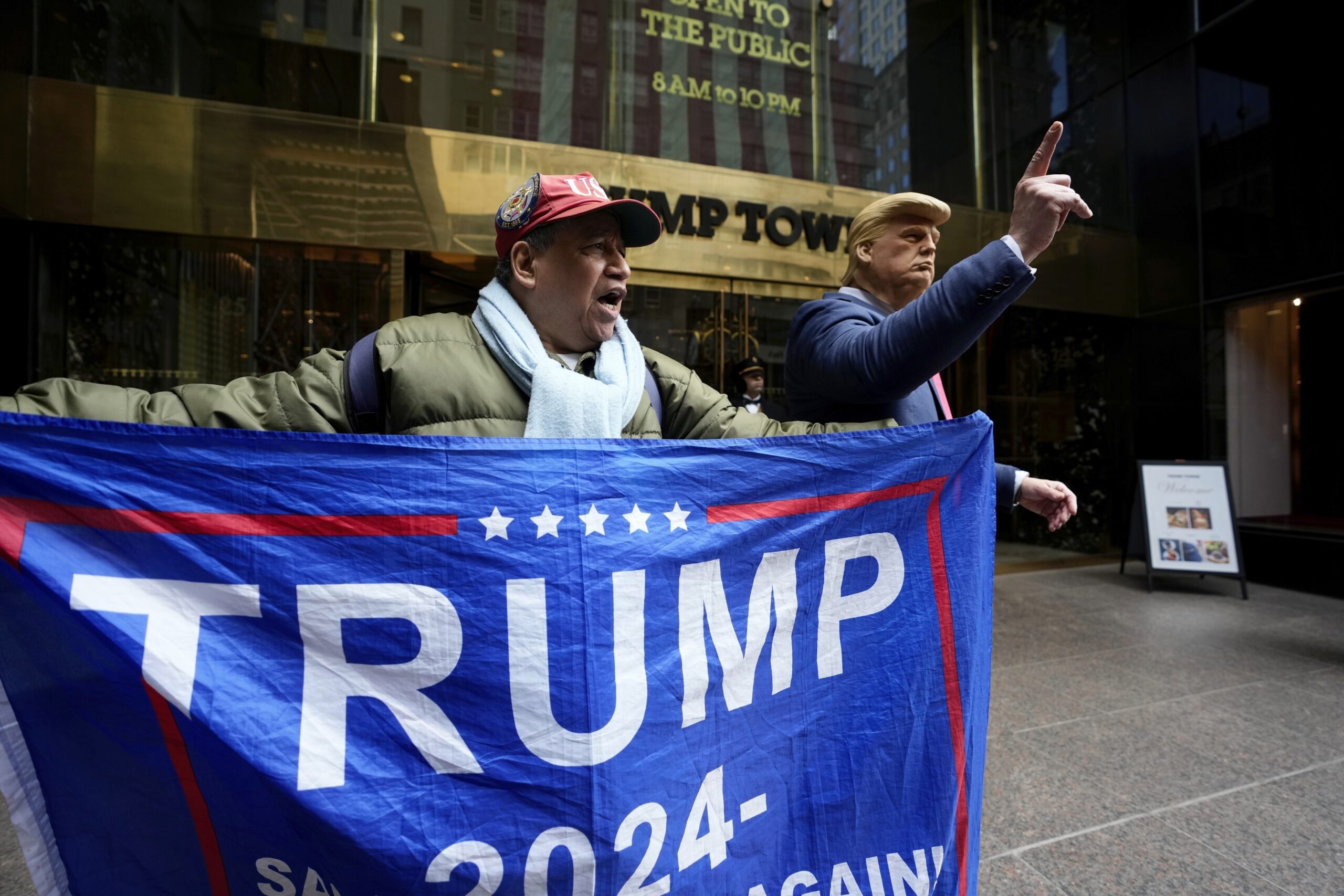 A supporter of former President Donald Trump, and a man impersonating the former president stand outside of Trump Tower on Friday, March 31, 2023, in New York