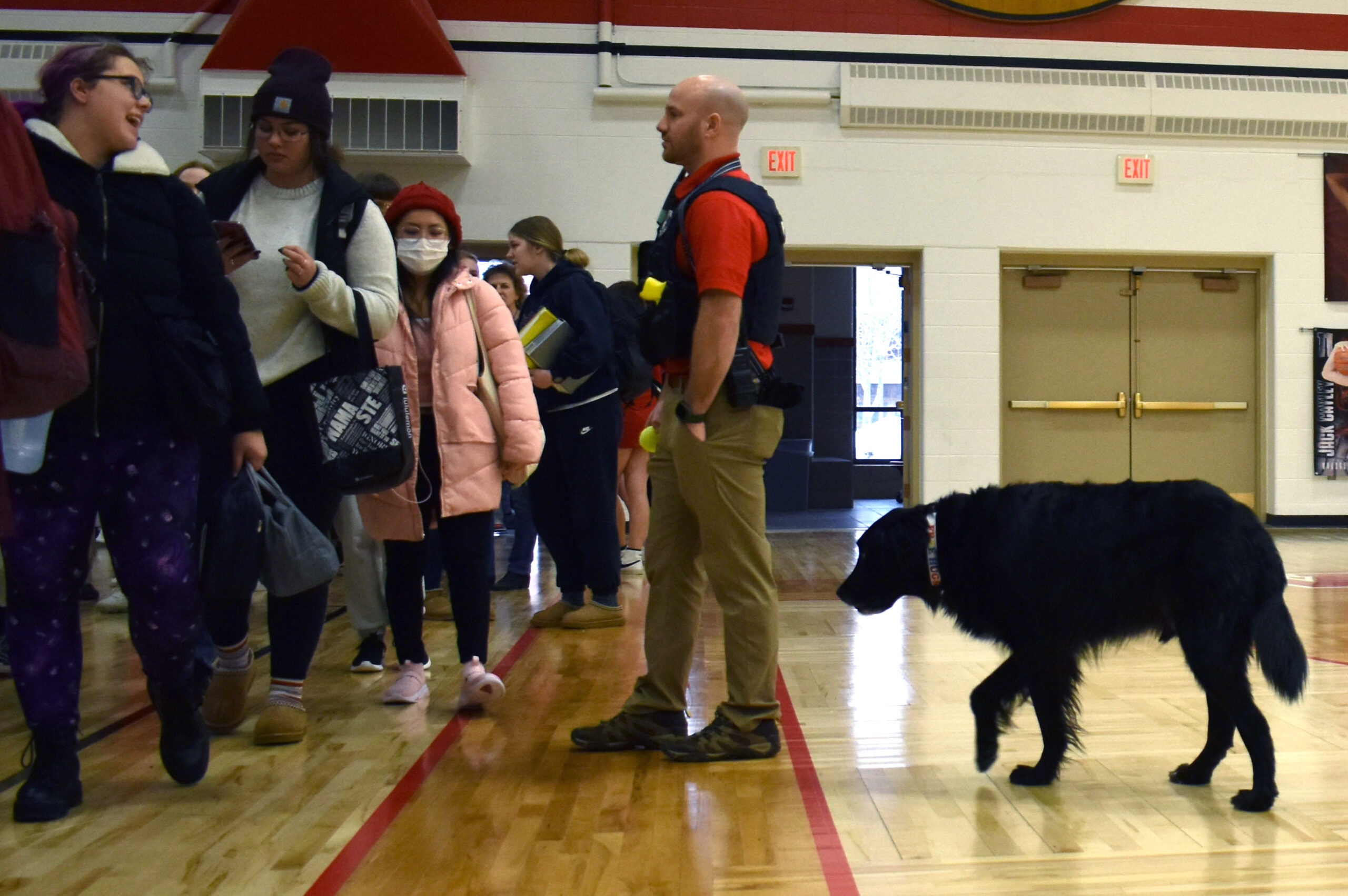 Wausau officer Nick Stetzer talks to students with therapy dog Badge