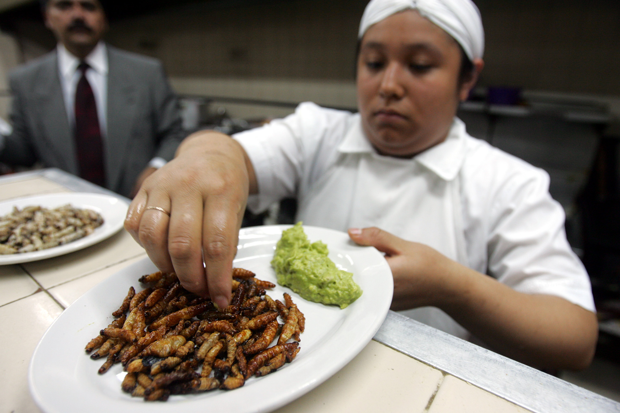 A cook serves deep-fried worms with A cook serves deep-fried worms with guacamole at the Hosteria Santo Domingo in Mexico City, Mexico.guacamole at the Hosteria Santo Domingo in Mexico City, Mexico