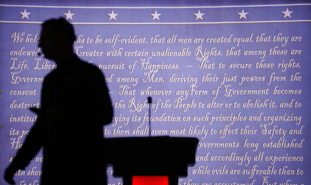 A producer walks past a podium on the stage for the presidential debate between Democratic presidential candidate Hillary Clinton and Republican presidential candidate Donald Trump at Hofstra University in Hempstead, N.Y., Monday, Sept. 26, 2016.