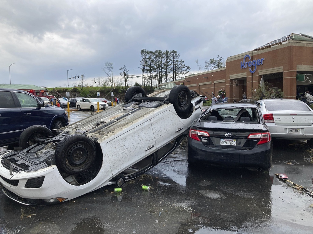 A car is upturned in a Kroger parking lot after a severe storm swept through Little Rock, Ark.