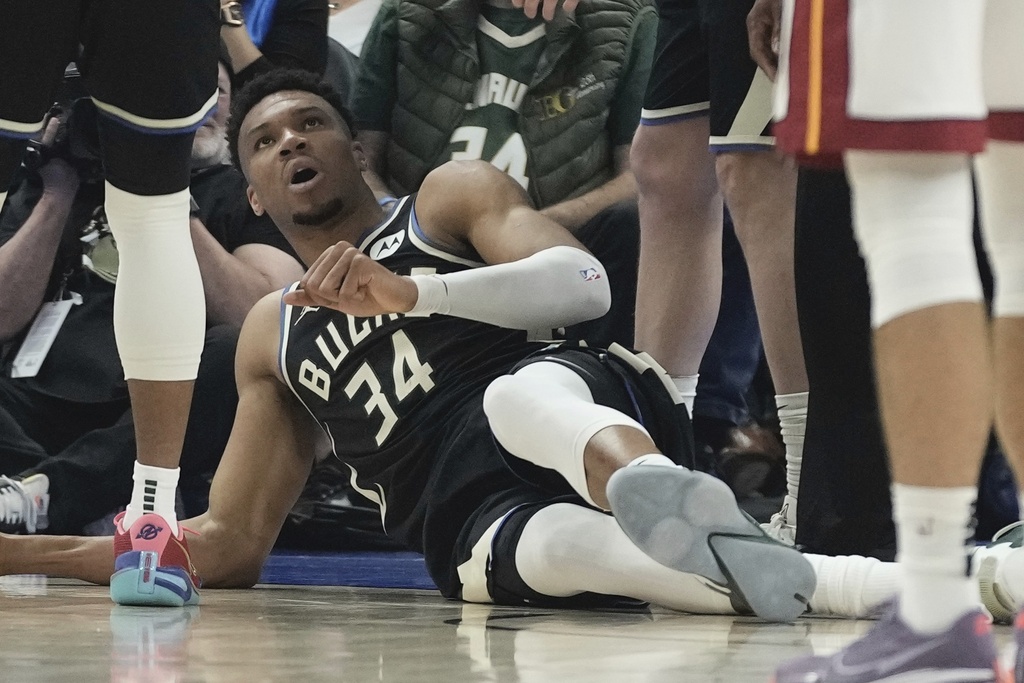Milwaukee Bucks' Giannis Antetokounmpo lies on the ground after an injury during the first half in Game 1 of an NBA basketball first-round playoff game