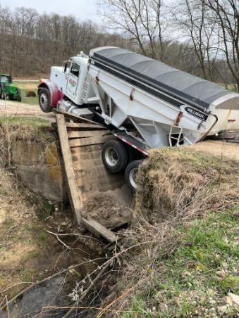 A creek crossing collapsed under a large truck
