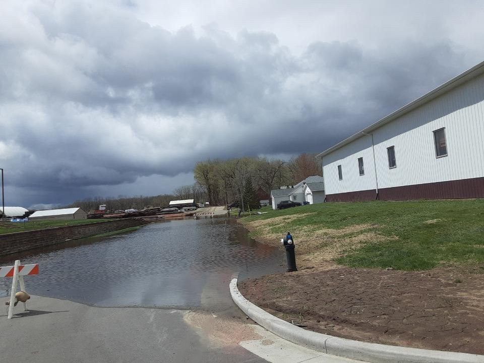 Floodwaters completely cover a small street