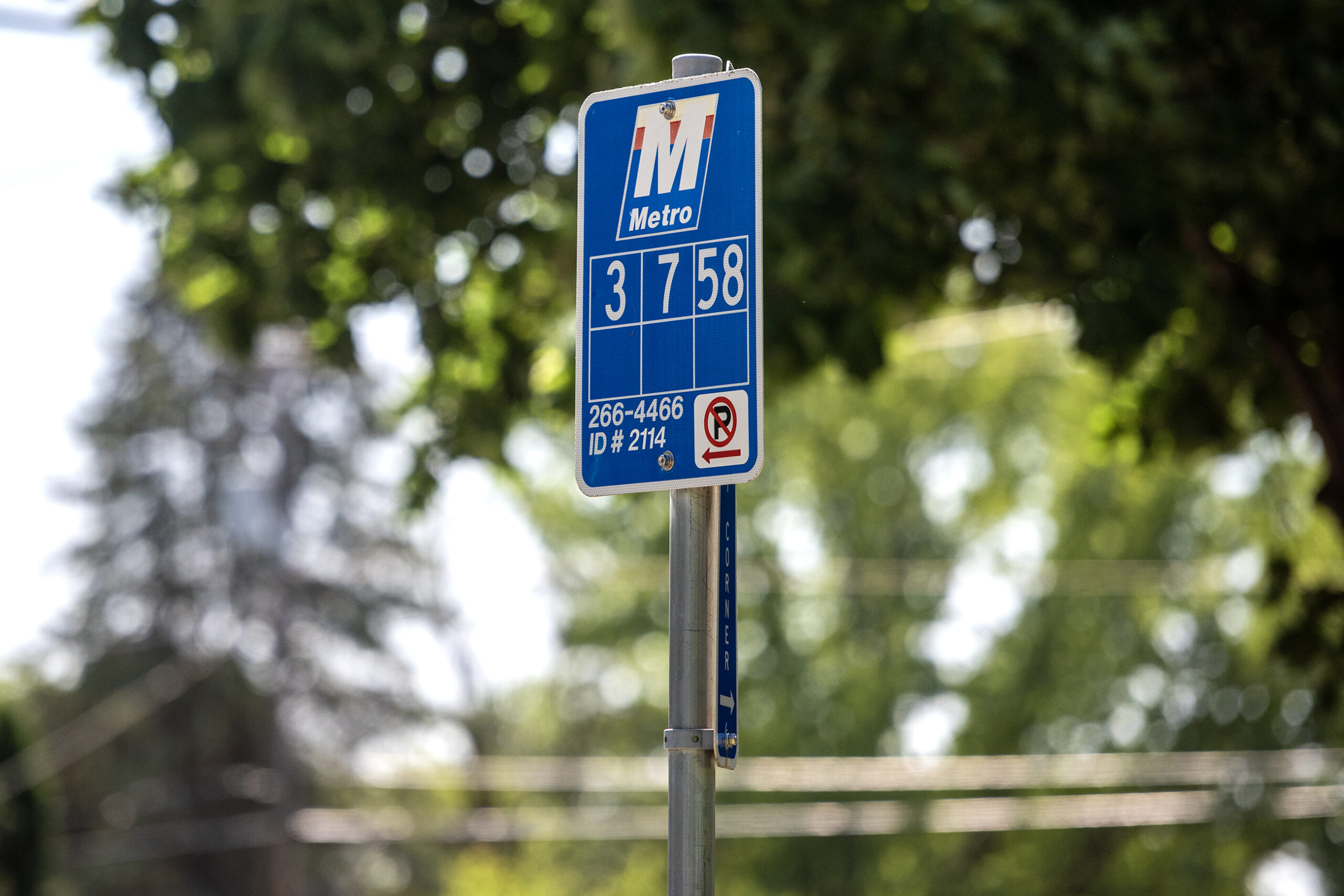 A blue sign with a Metro logo and numbers to indicate the stop.